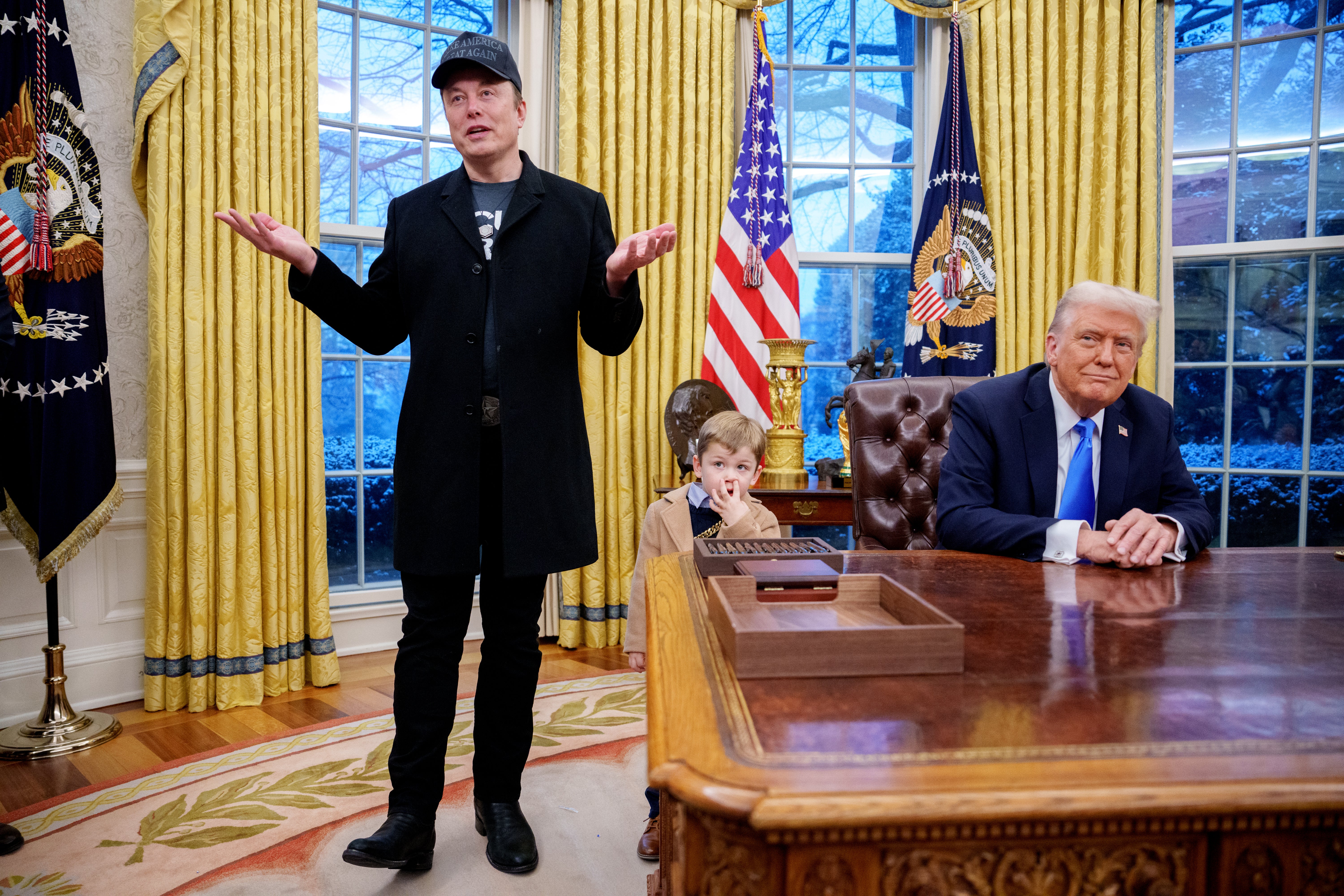 Tesla and SpaceX CEO Elon Musk, accompanied by U.S. President Donald Trump (R), when Trump signed an executive order implementing the Department of Government Efficiency's (DOGE) "workforce optimization initiative," on February 11, 2025.