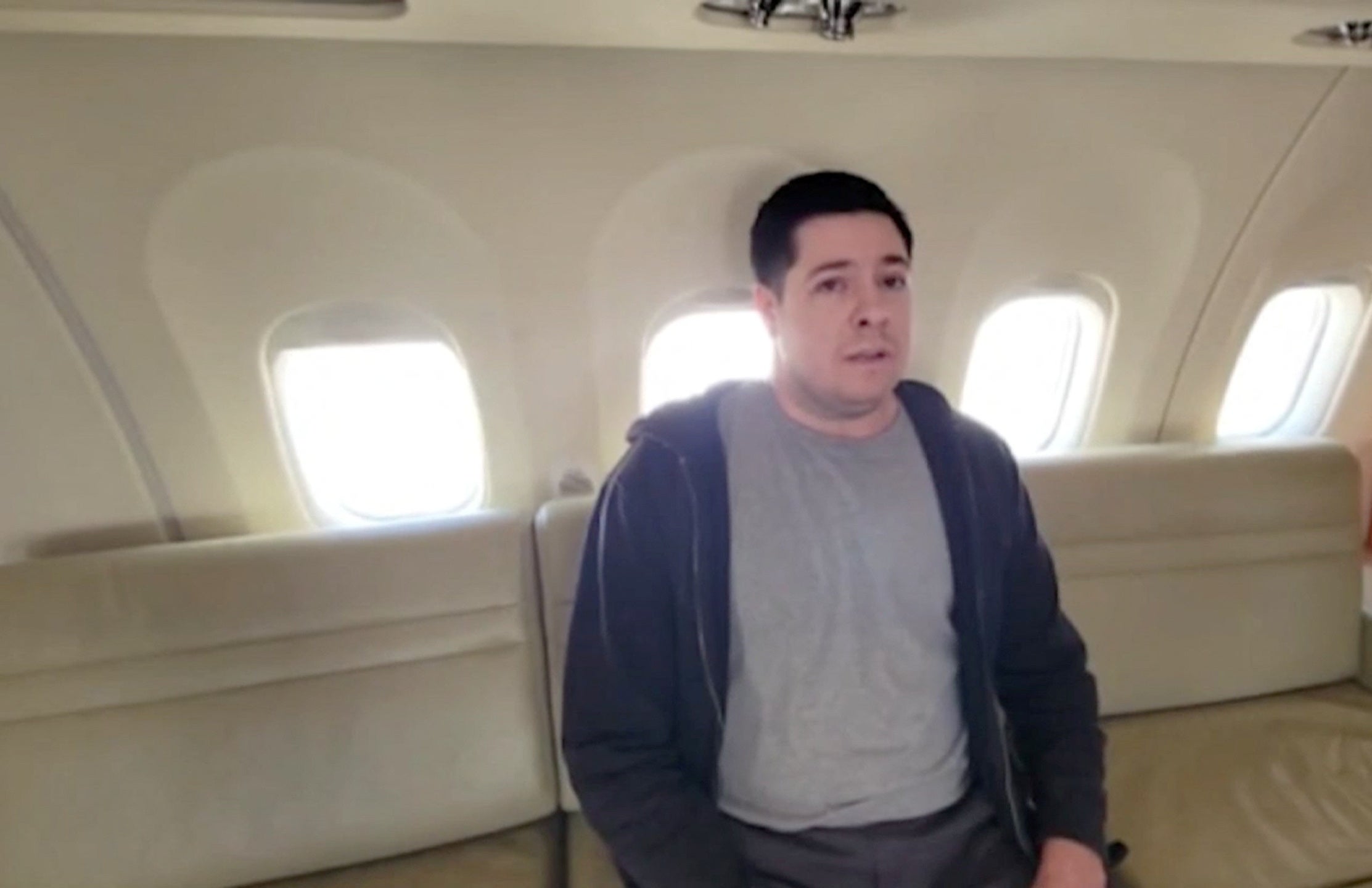 Arthur Petrov sits in a plane during a prisoner swap between Russia and the United States in Abu Dhabi