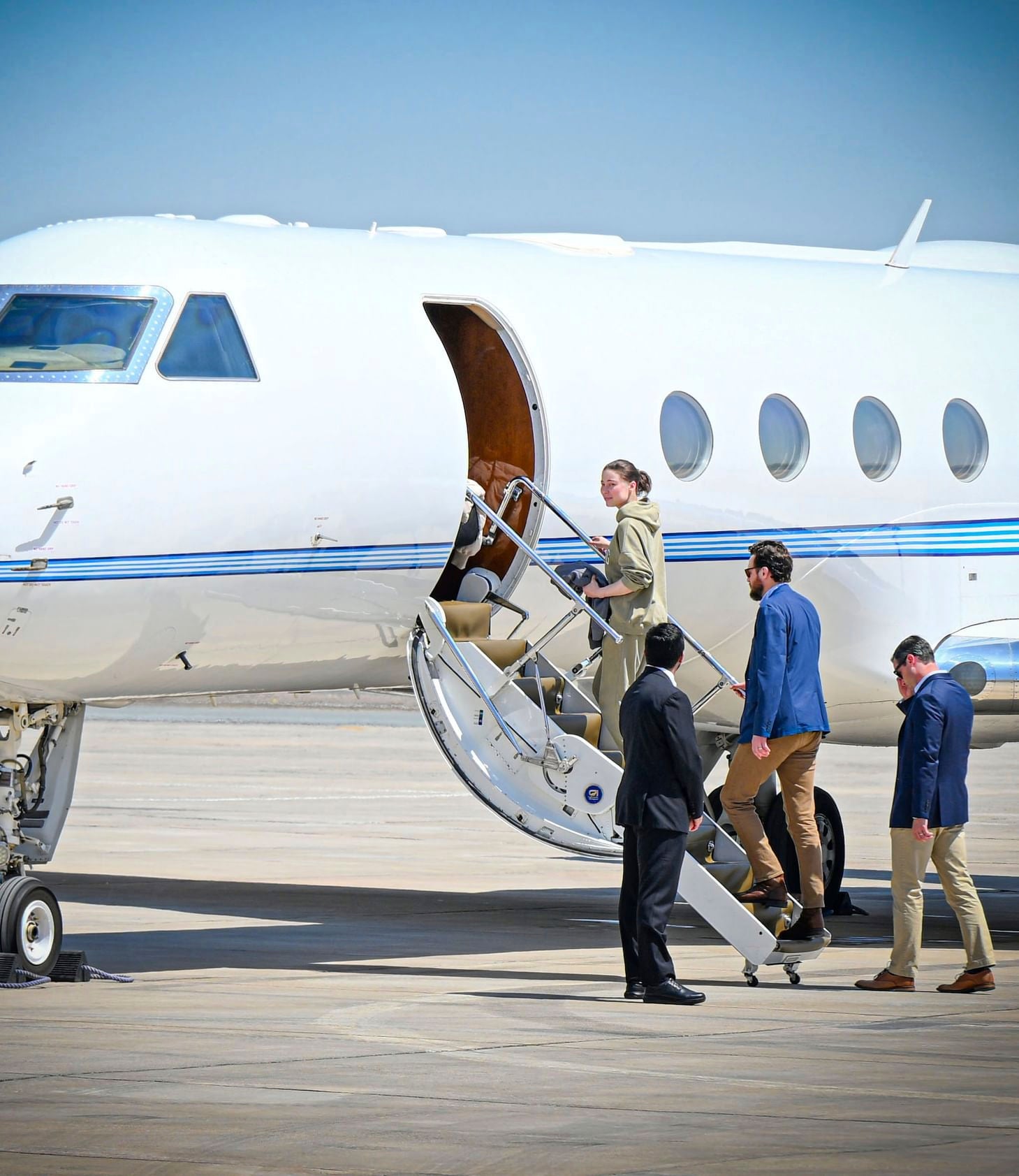 Karelina gets on a private jet after her release at an airport in Abu Dhabi