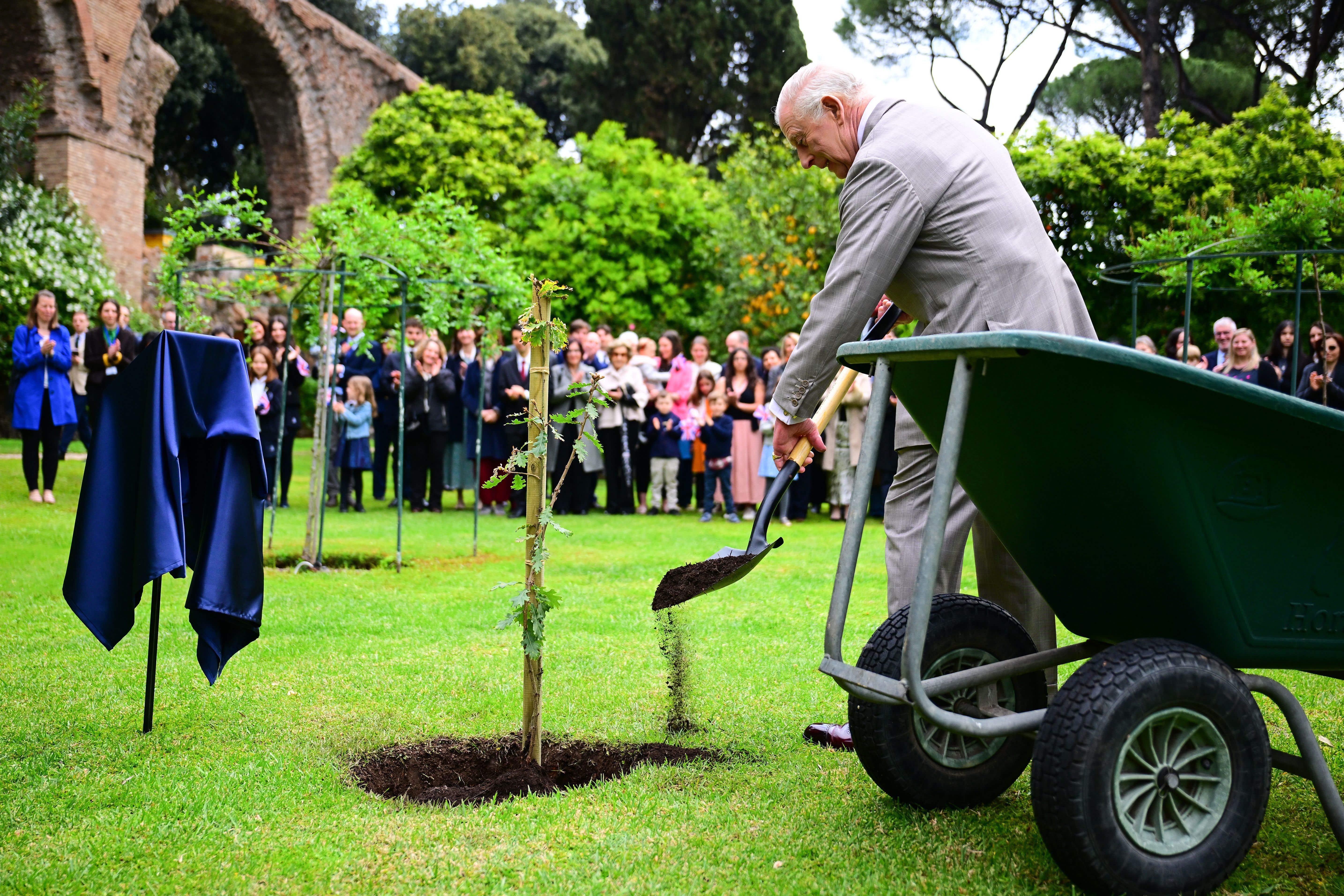 Charles beds in a sapling donated by Italian President Sergio Mattarella in the gardens of Villa Wolkonsky in Rome (Victoria Jones/PA)