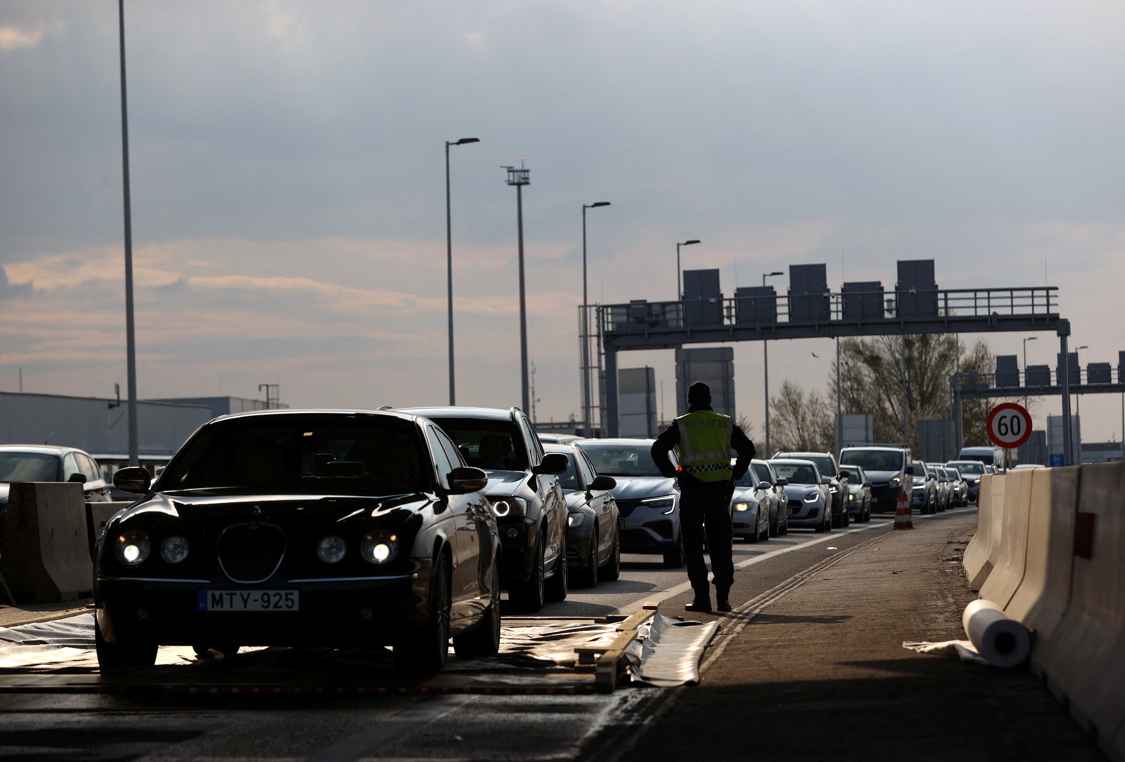 Cars drive through a disinfectant mat during the outbreak of foot-and-mouth disease