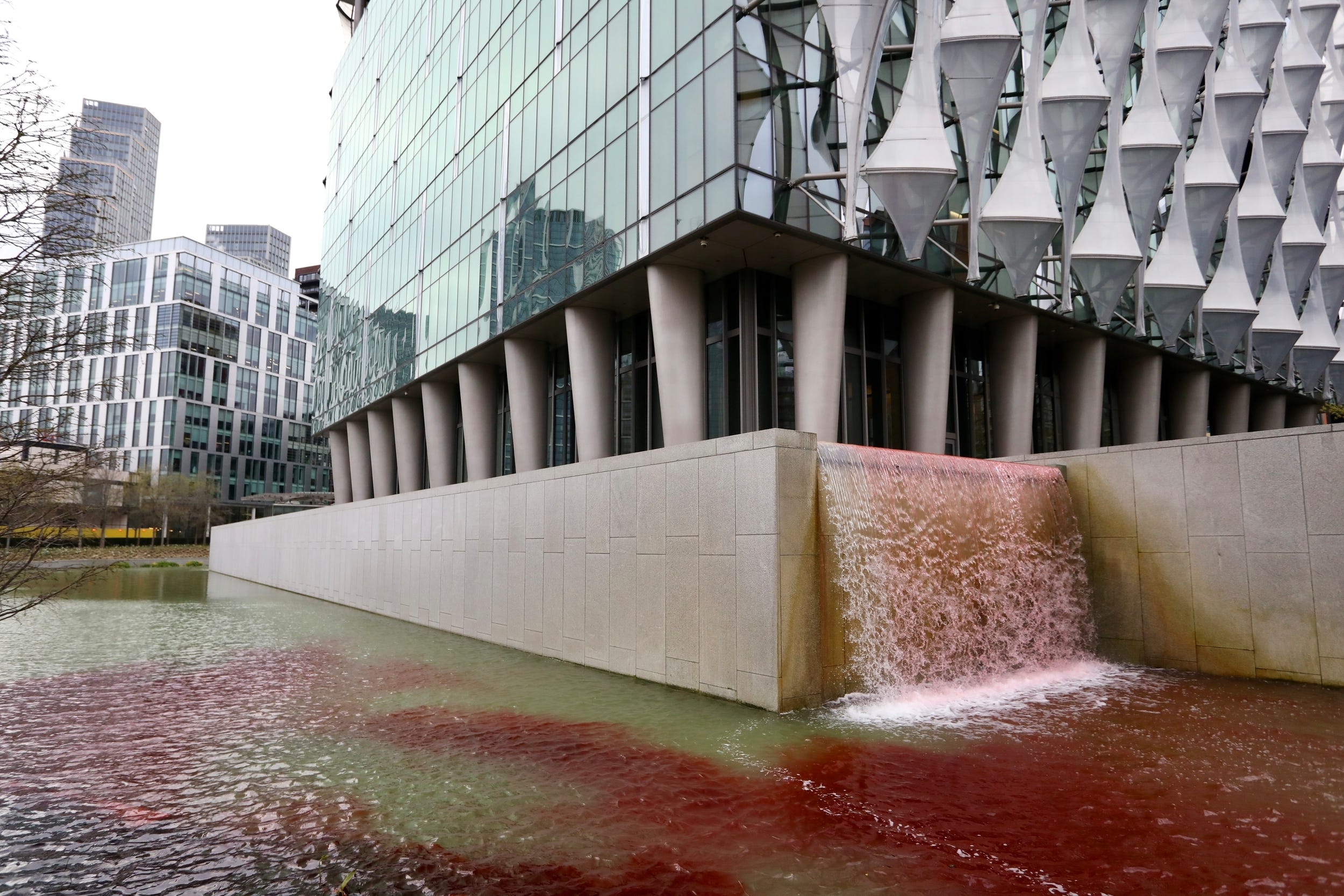 Activists poured dye into the US embassy pond in London (Greenpeace/PA)