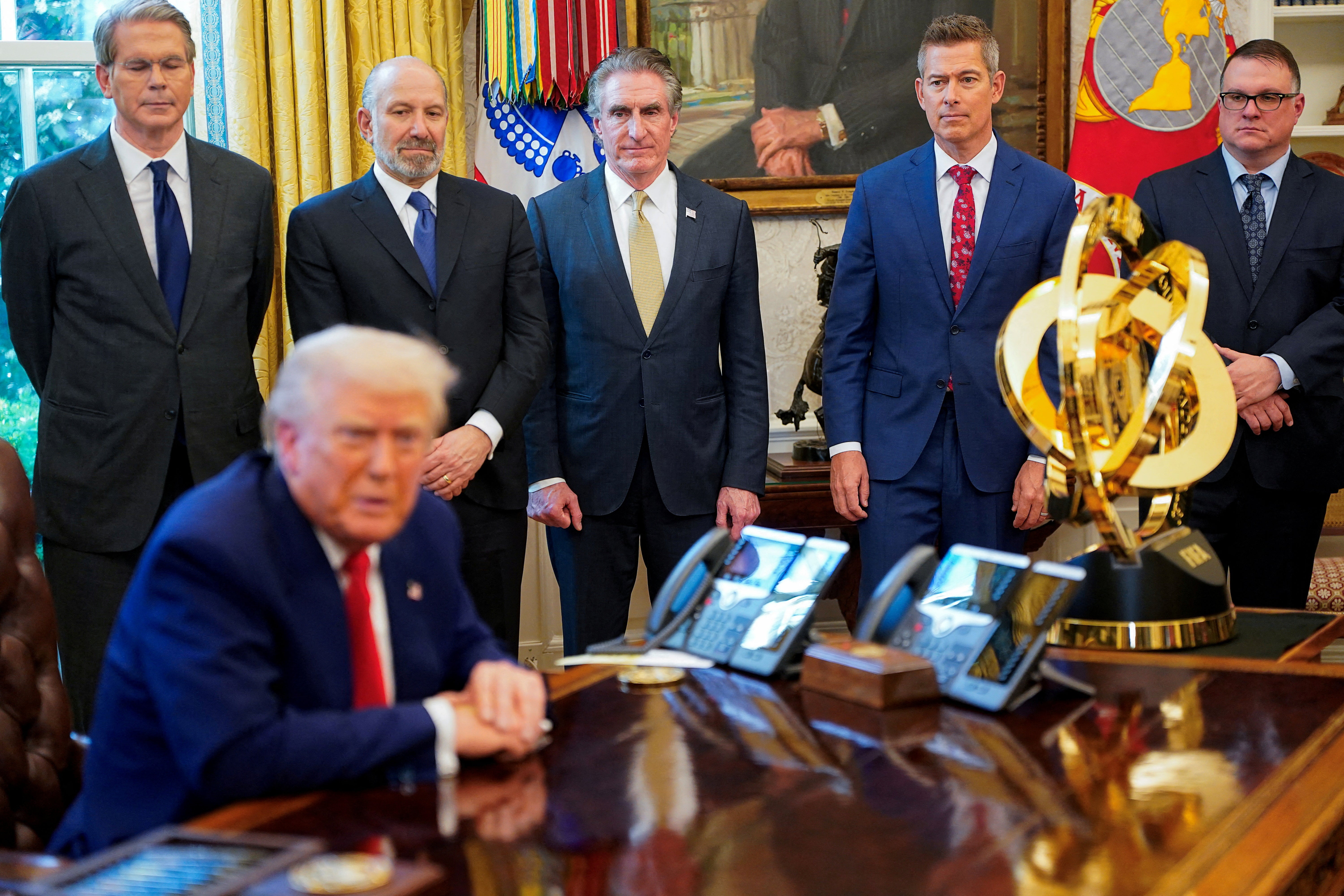 President Donald Trump flanked by members of his economic team including Scott Bessent, Howard Lutnick and Doug Burgum. Bessent poured cold water on the idea Americans could get rebate checks from tariff funds.