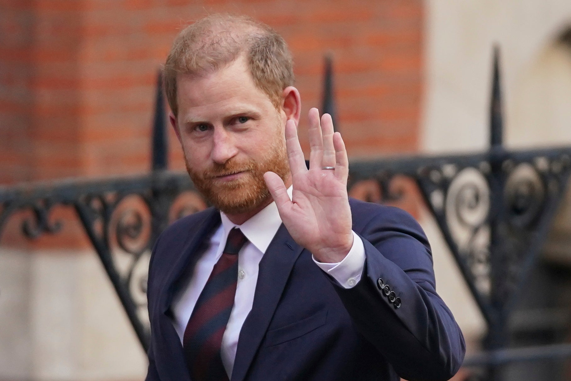 Prince Harry waves as he leaves the Royal Courts of Justice in London during his legal challenge