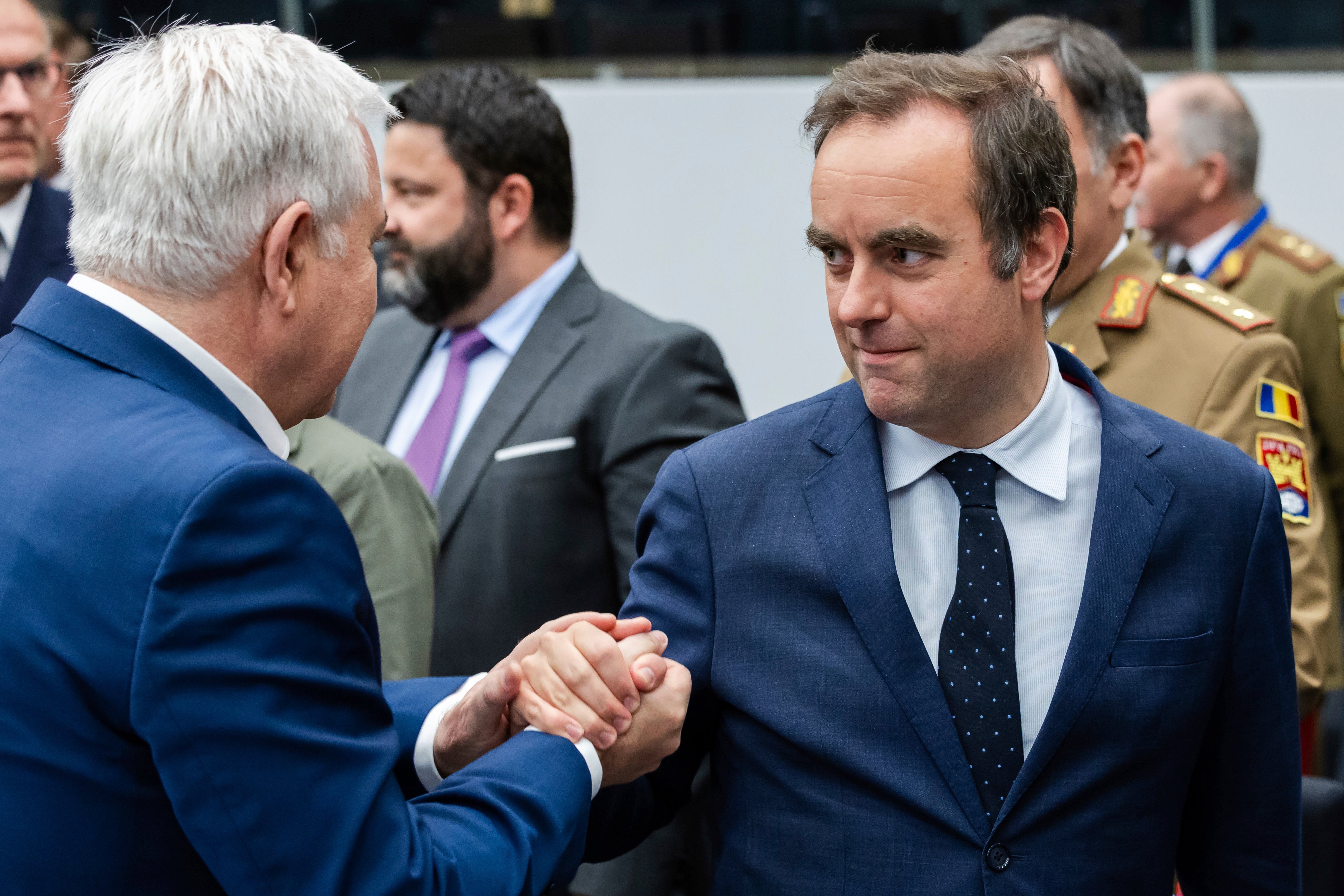 French Defense Minister Sebastien Lecornu, right, talks with Romania's Defense Minister Angel Tilvar as they arrive for a coalition of the willing defence ministers meeting at NATO headquarters in Brussels, Belgium, Thursday, April 10, 2025. (AP Photo/Geert Vanden Wijngaert)
