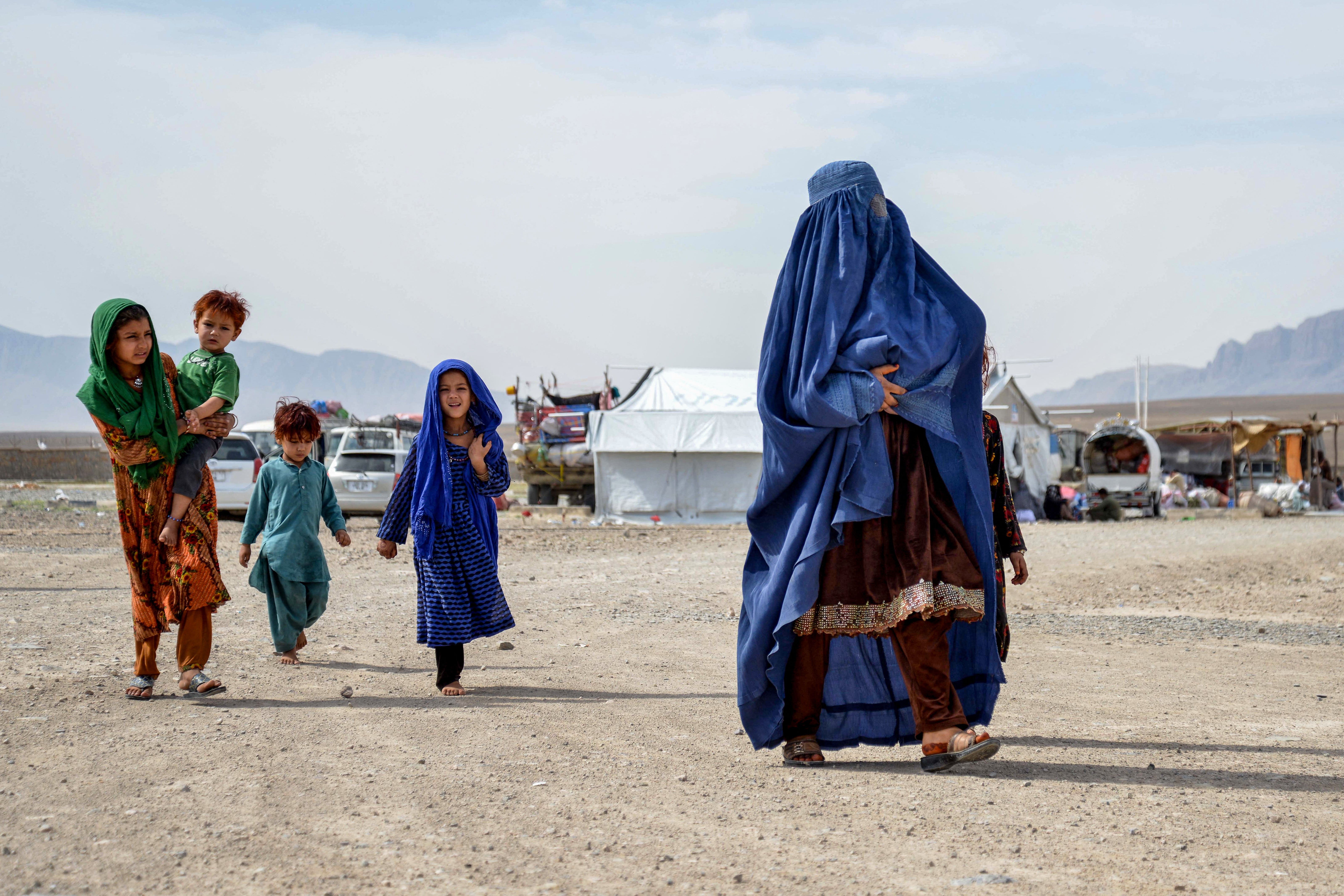An Afghan refugee and her children arrive at a registration centre in the Takhta Pul district of Kandahar province