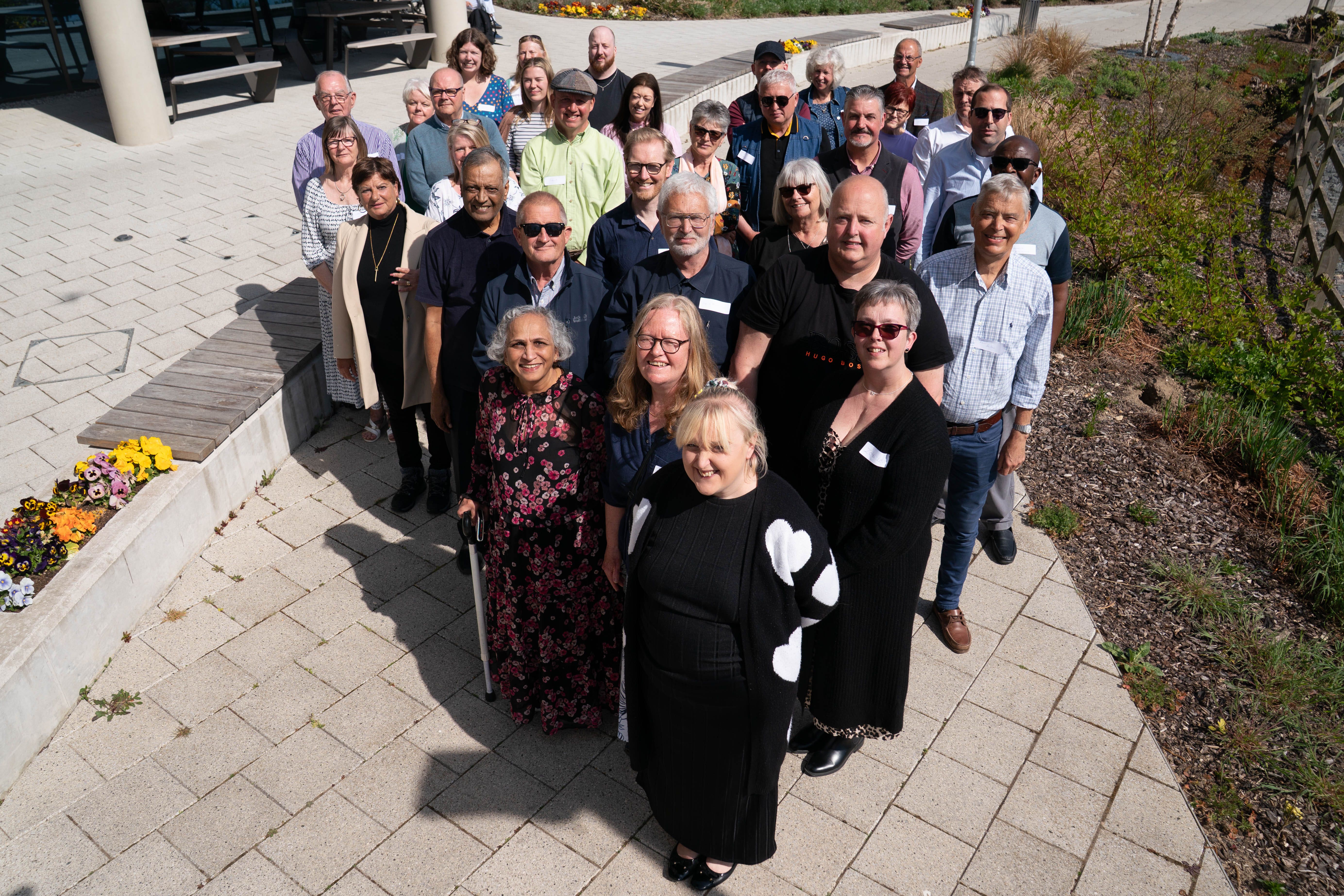 Twenty recipients of heart transplants and their families pose for a photograph at a celebration event at the Royal Papworth Hospital in Cambridge (Stefan Rousseau/PA)