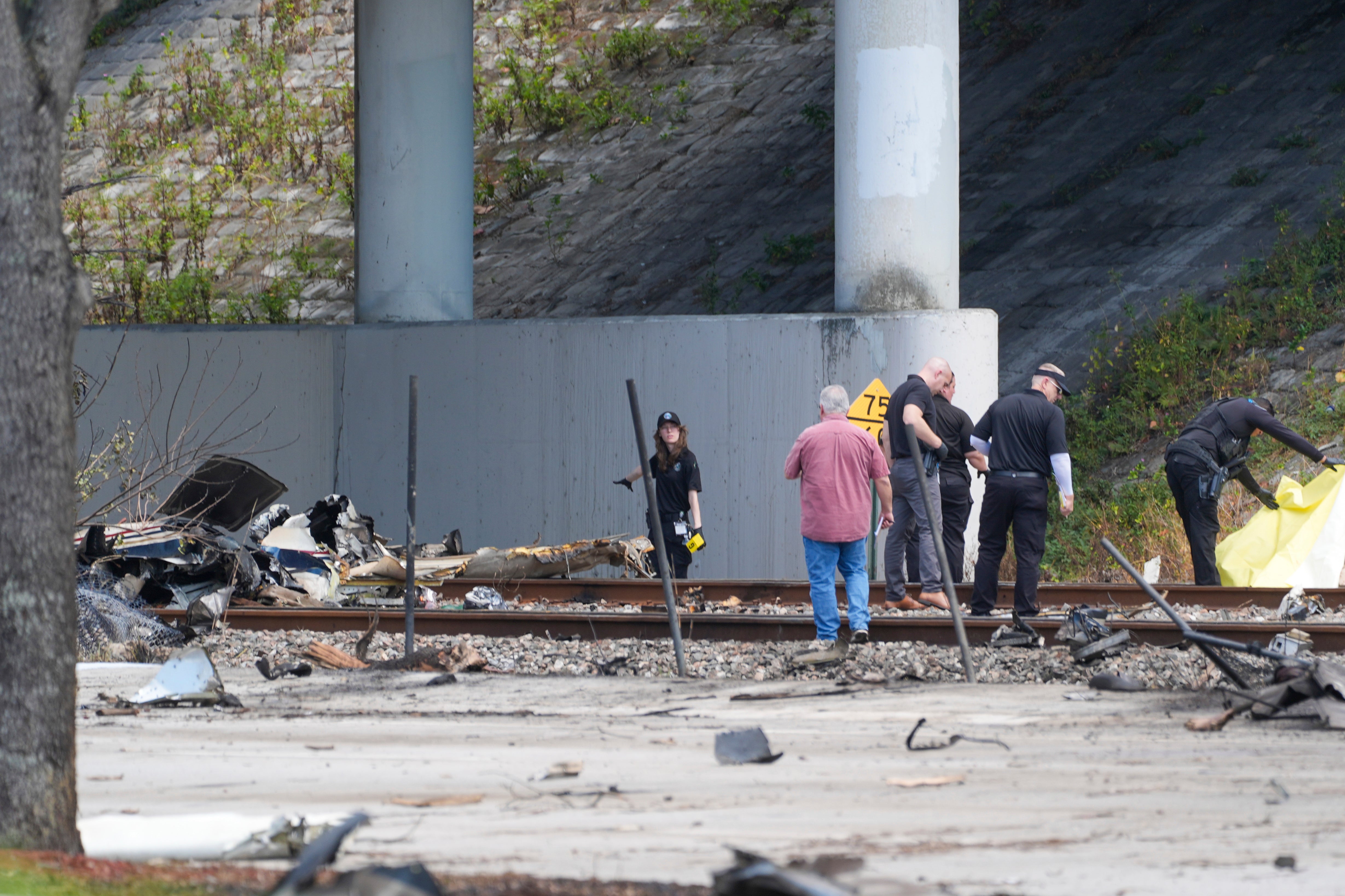 Emergency crew inspect the site of a small plane crash in Boca Raton on Friday