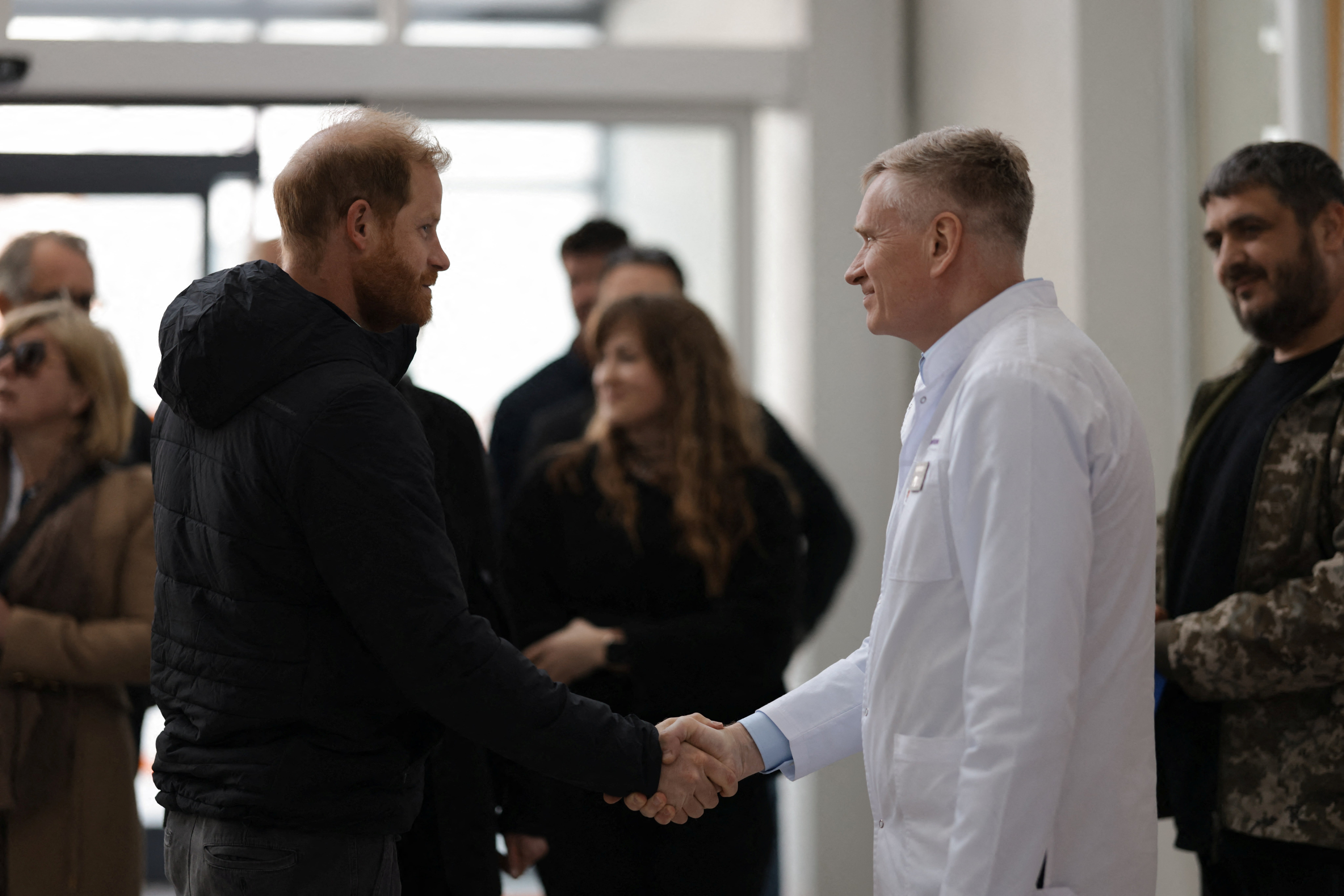 Britain's Prince Harry shakes hands with a member of medical staff as he visits the Superhumans Centre in Lviv, Ukraine