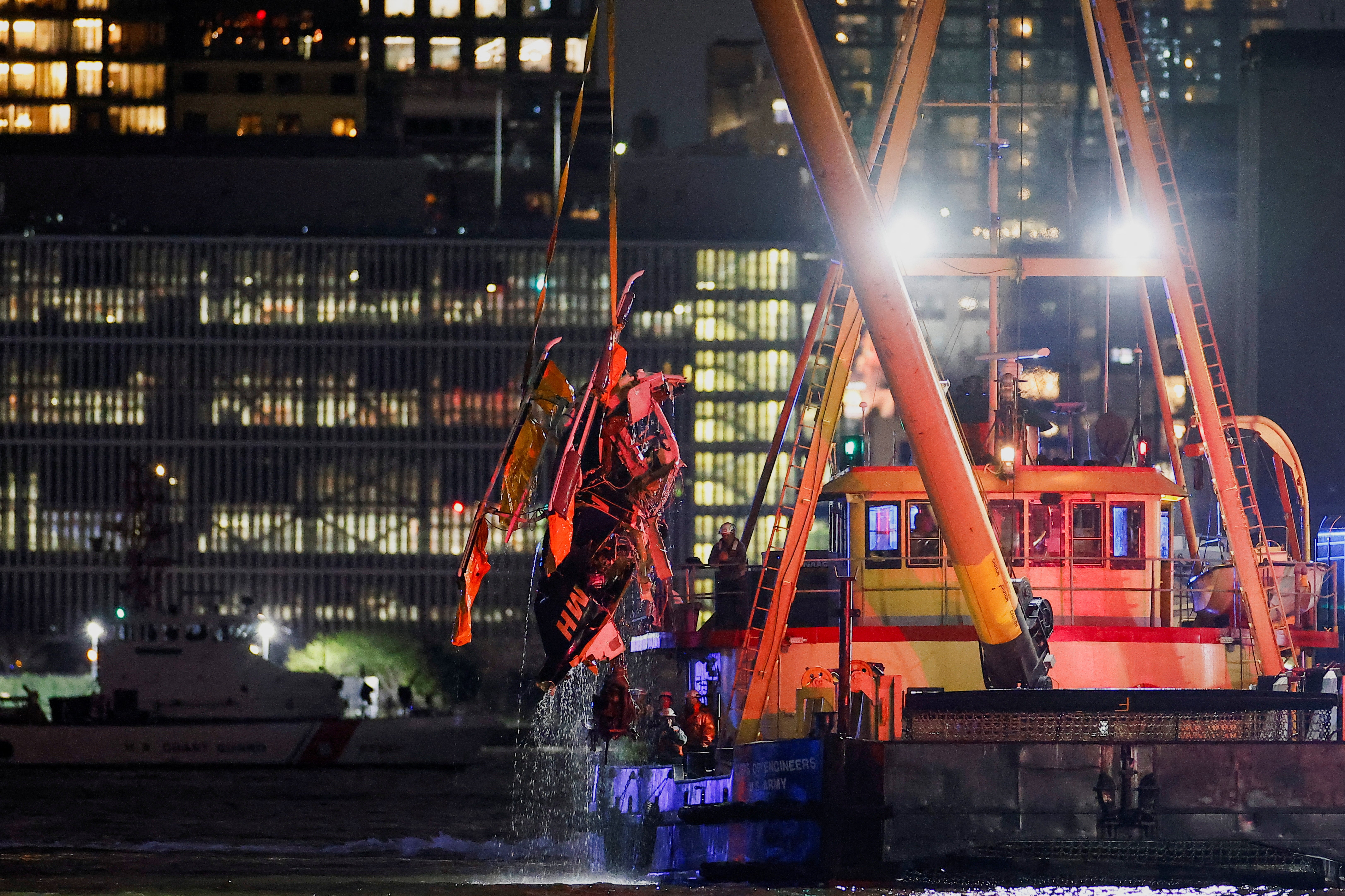 Emergency personnel work at the scene of a helicopter crash on the Hudson River near lower Manhattan in New York, as seen from Newport, New Jersey U.S., April 10, 2025. REUTERS/Eduardo Munoz