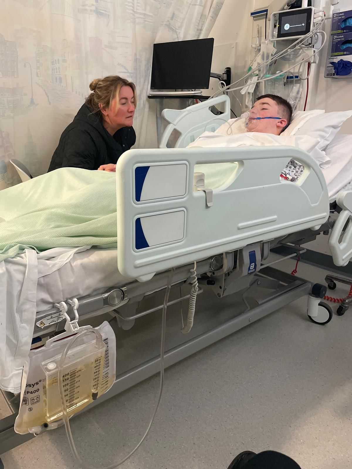 Charlotte King sat by her son, Roman, in hospital