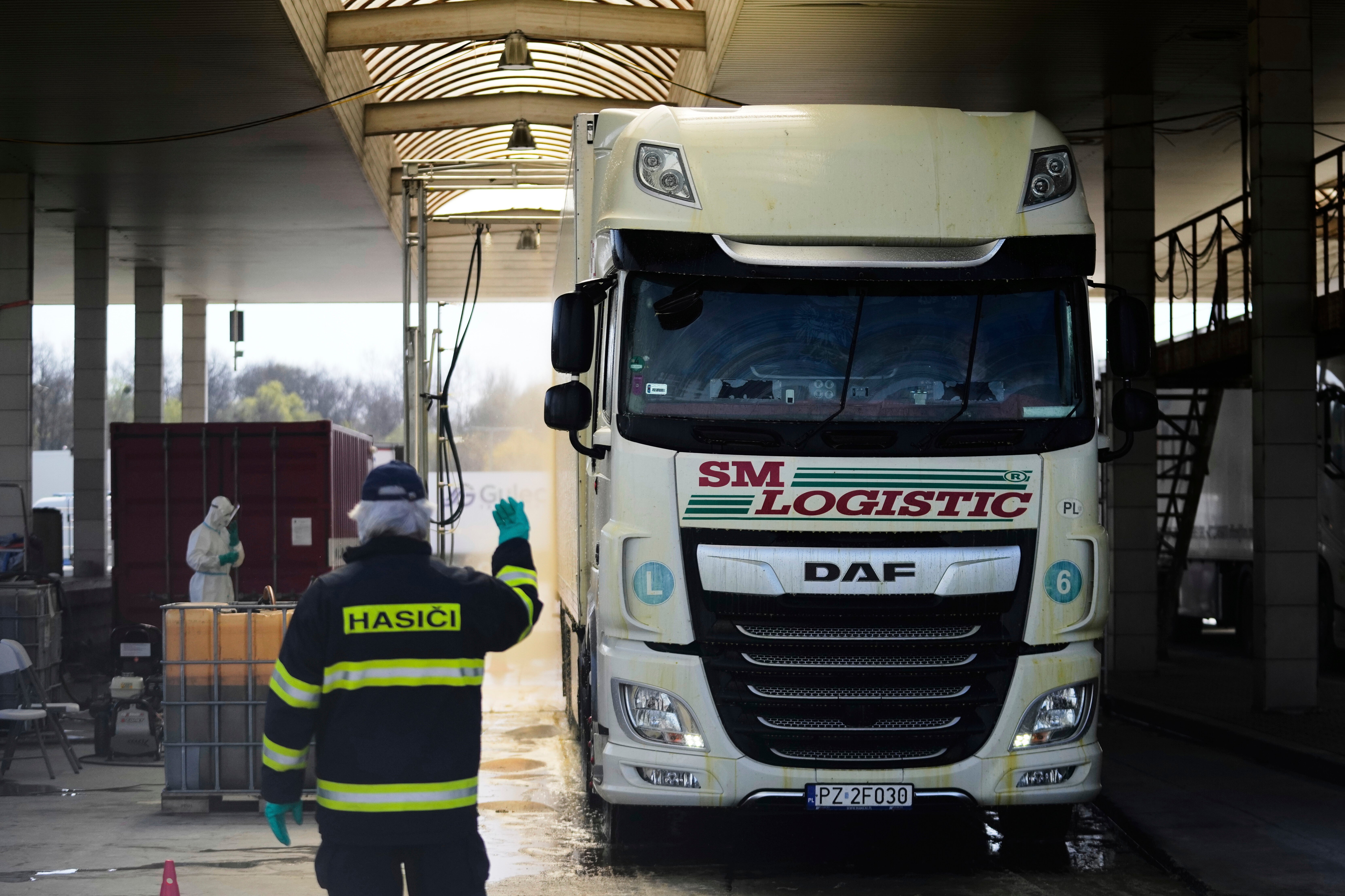 A truck drives through a shower of disinfectant in affords to prevent the spread of a the highly infectious foot-and-mouth disease from Slovakia at the border in Lanzhot, Czech Republic, Friday, April 11, 2025