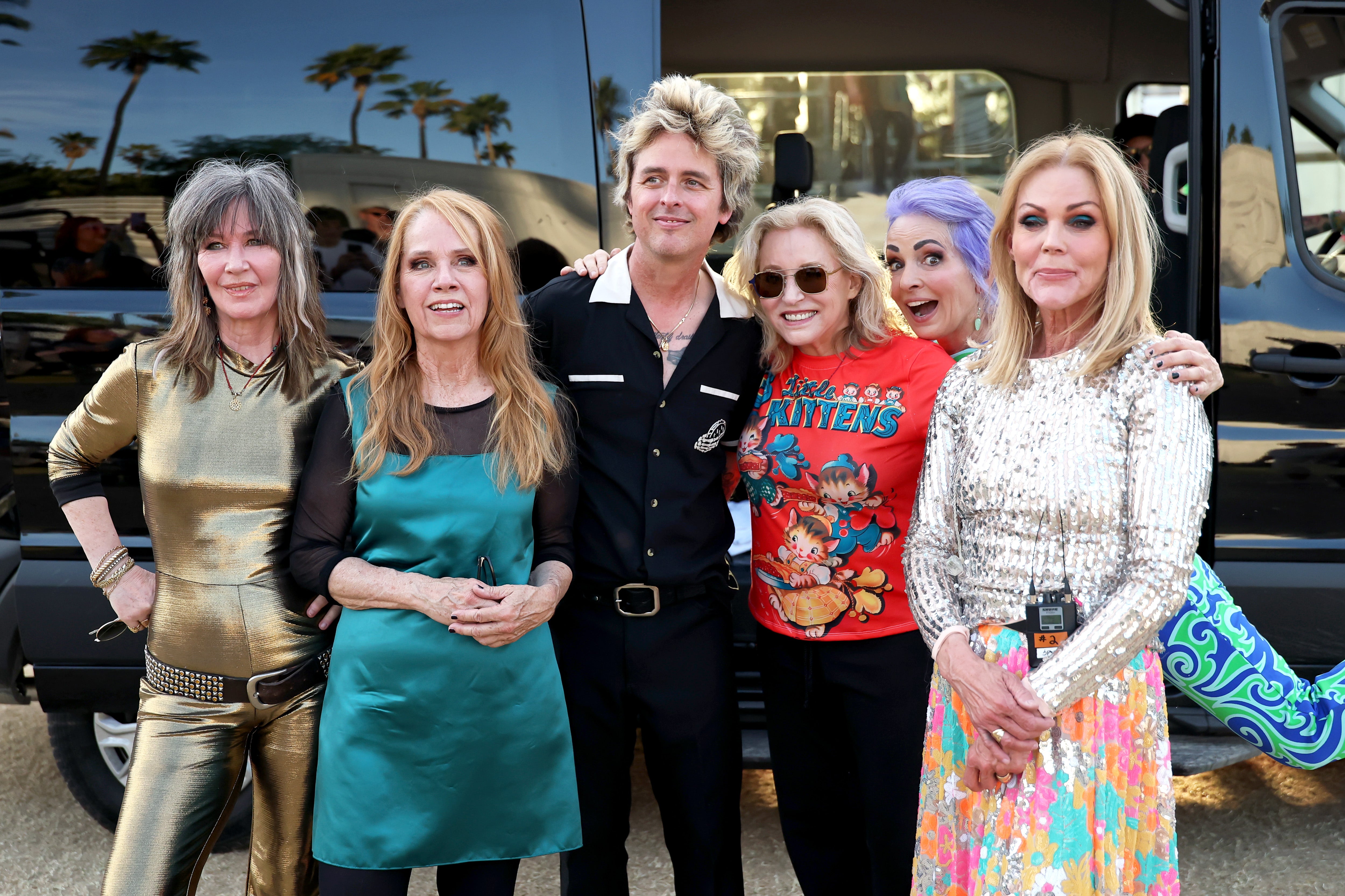 Billie Joe Armstrong (third from left) with The Go-Go's: (left-right) Kathy Valentine, Charlotte Caffey, Gina Schock, Jane Wiedlin and Belinda Carlisle backstage at Coachella 2025