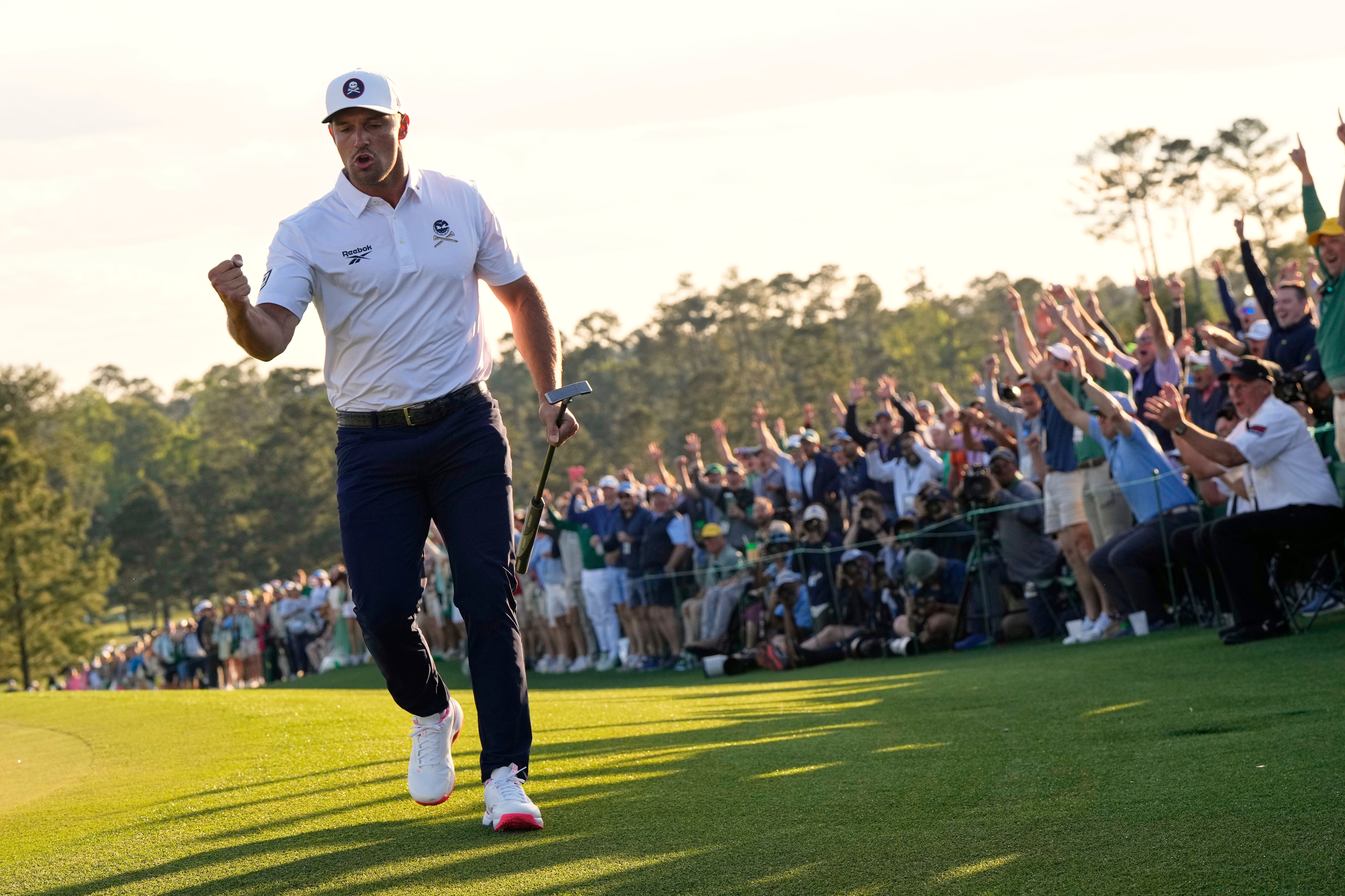 Bryson DeChambeau celebrates after a birdie on the 18th hole during the third round at the Masters (David J Phillip/AP)