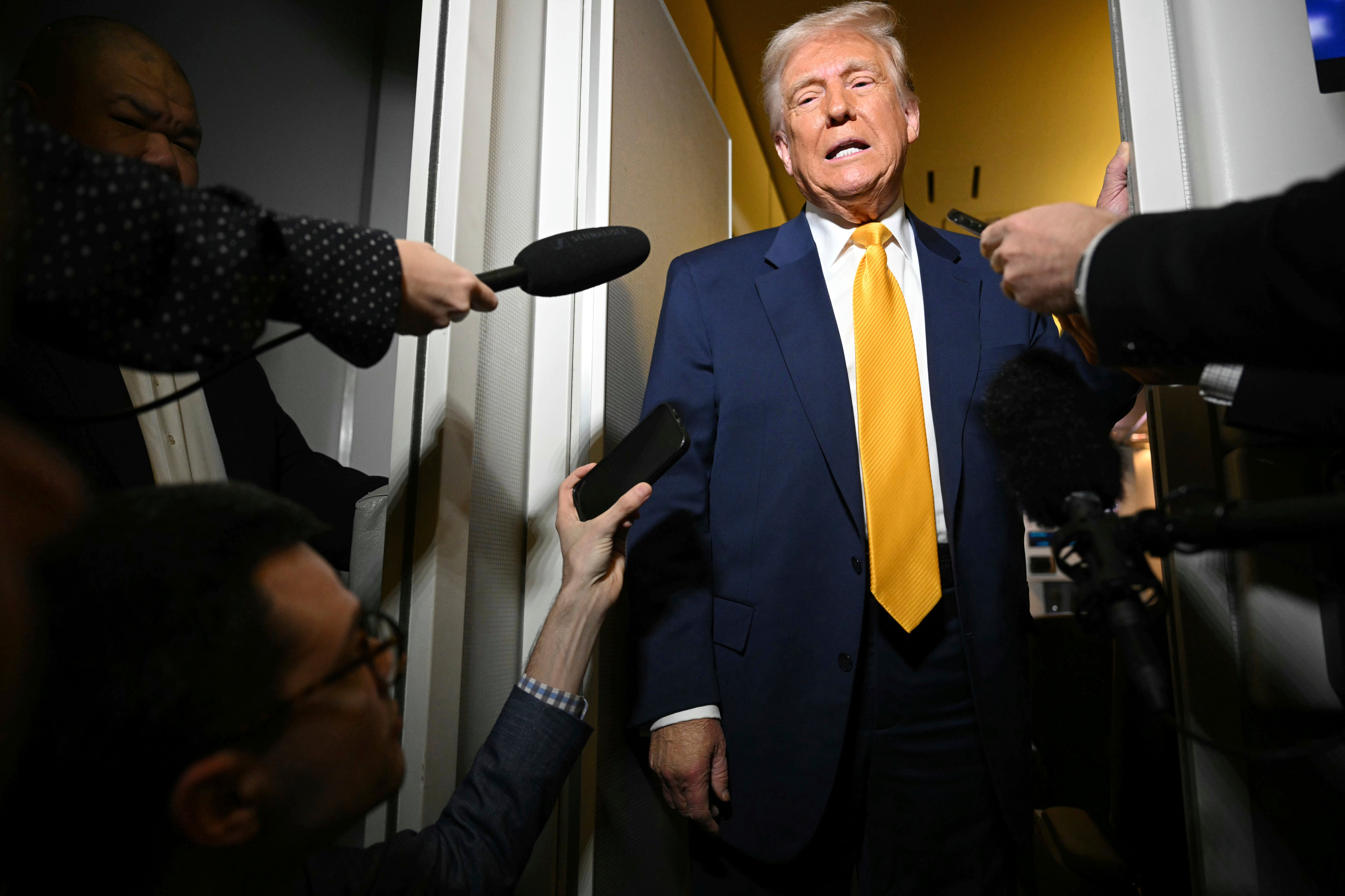 President Donald Trump speaks to the reporters on board Air Force One on the way to Miami, Saturday, April 12, 2025