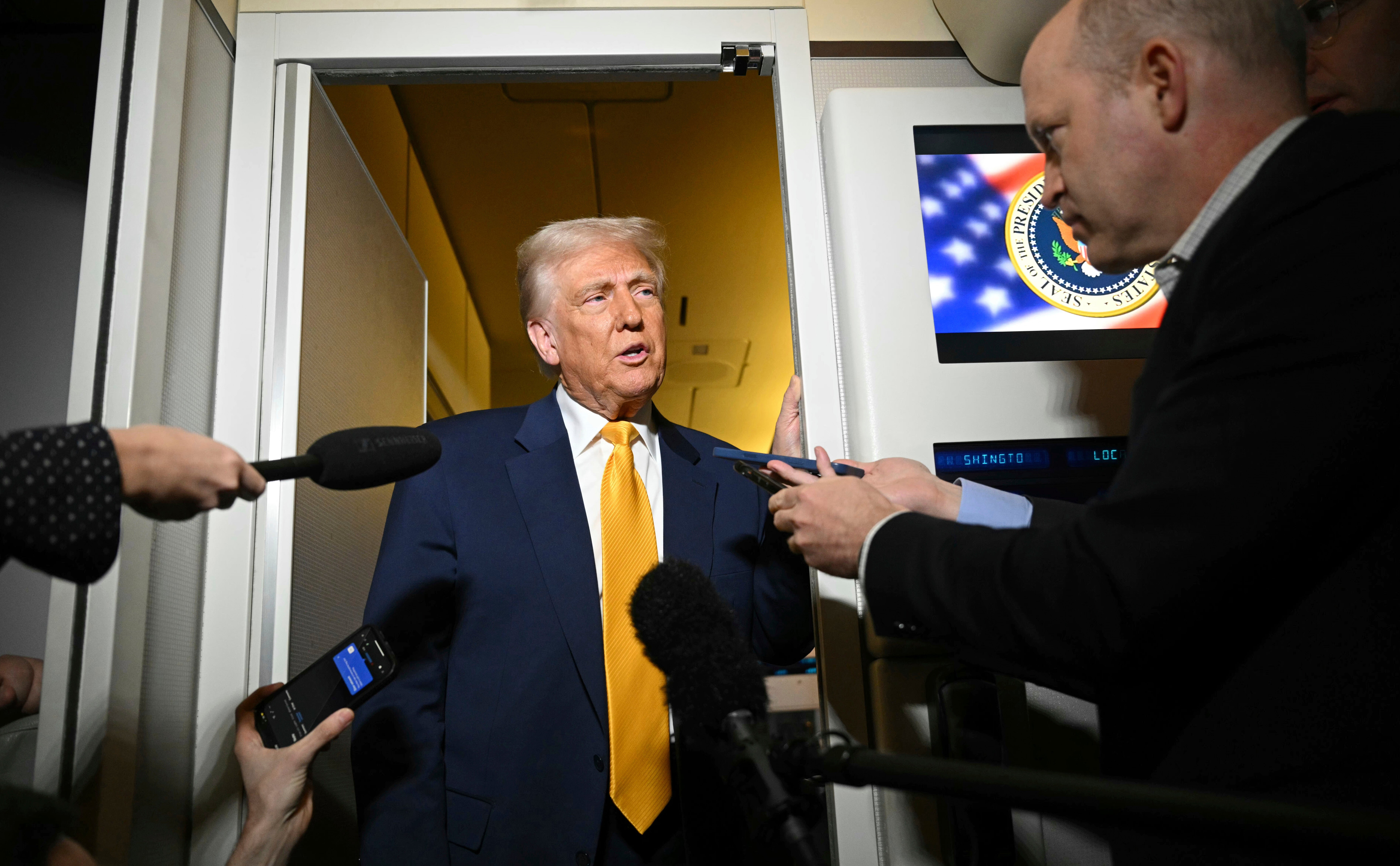 President Donald Trump speaks to the reporters on board Air Force One on the way to Miami, Saturday, April 12, 2025
