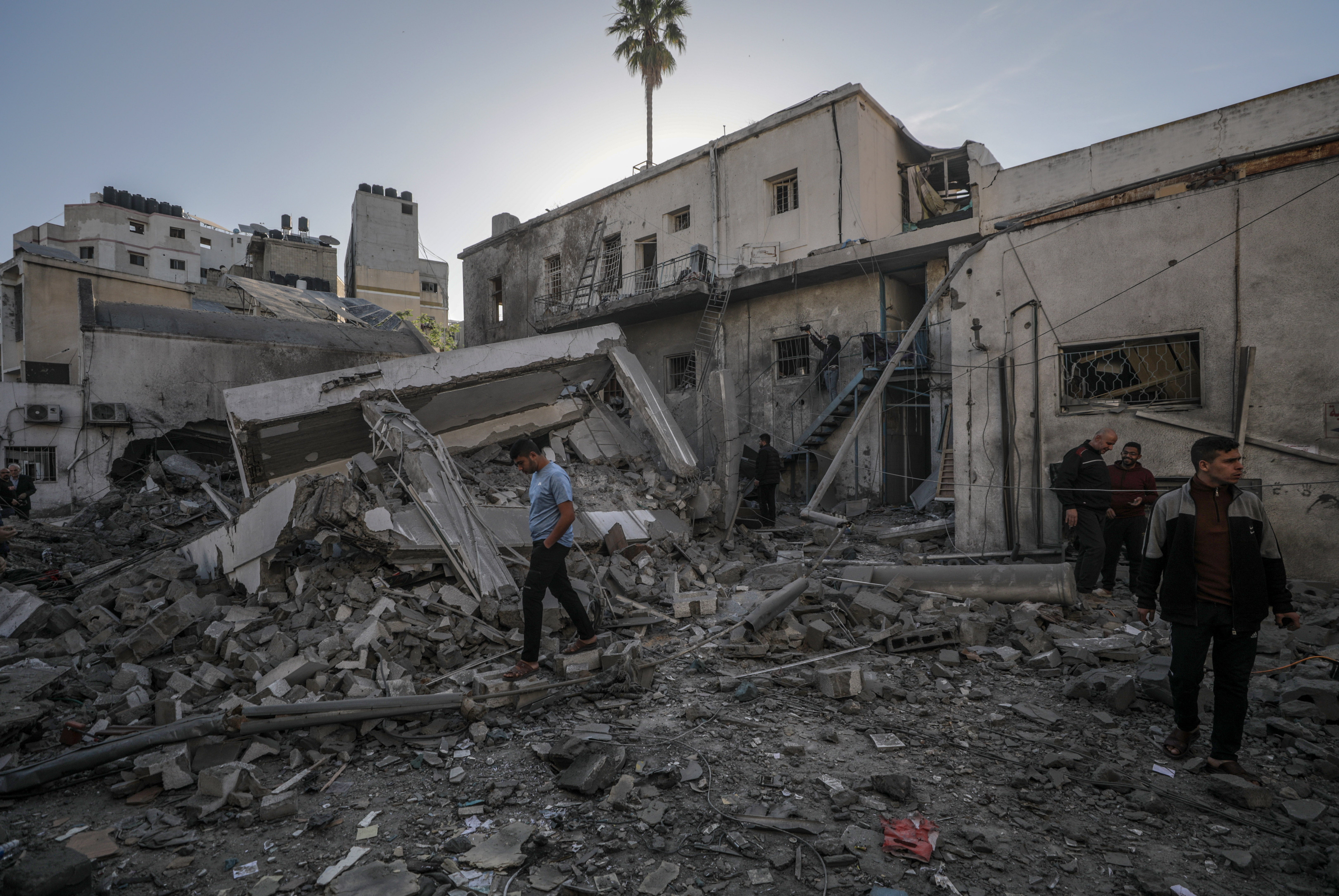 Palestinians at the site of the destroyed building of al-Ahli Baptist hospital
