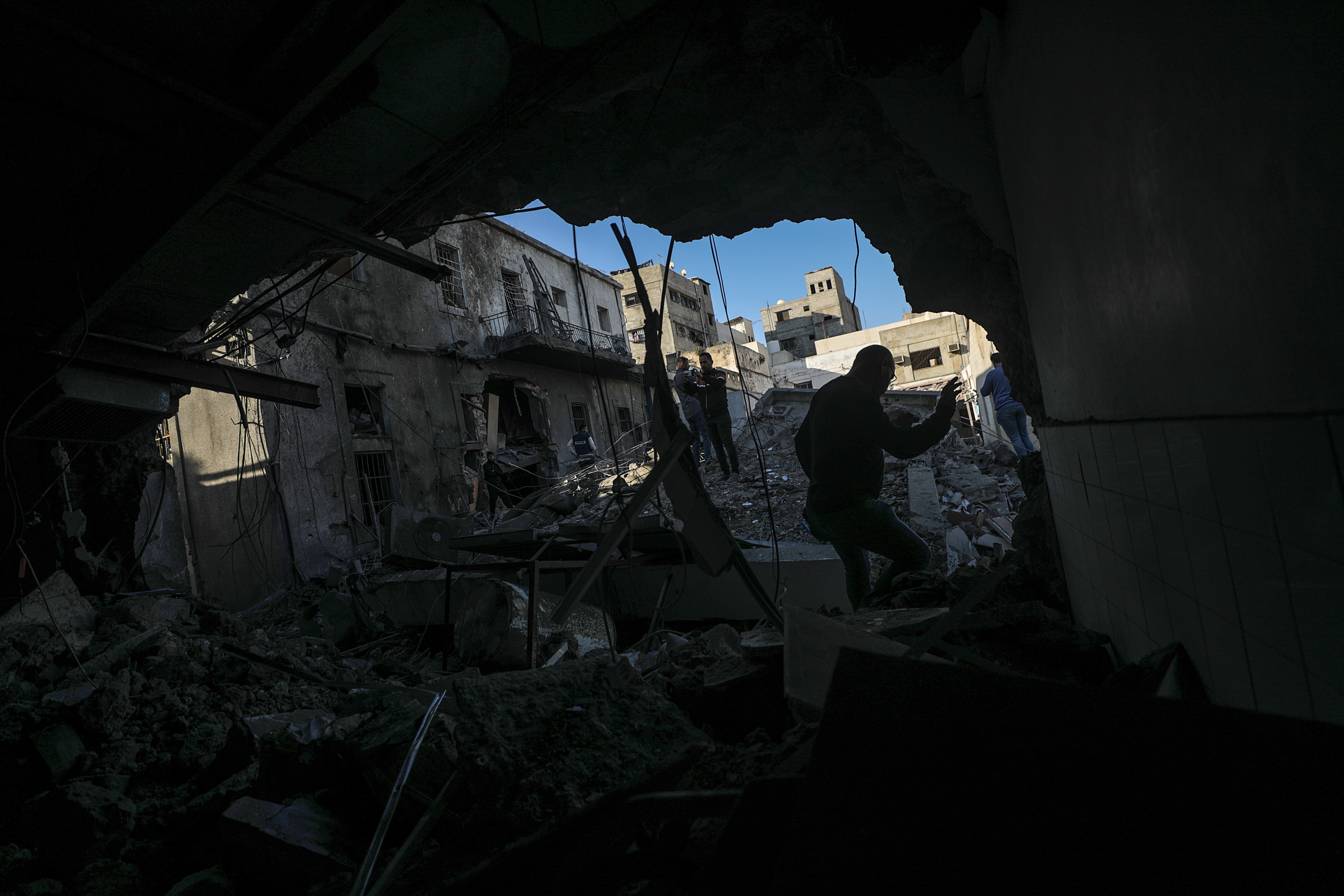 Palestinians at al-Ahli Baptist Hospital after it was partly destroyed by an Israeli airstrike
