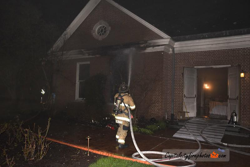 Firefighters extinguish flames at Pennsylvania Governor Josh Shapiro's residence after an arsonist set fire to the building