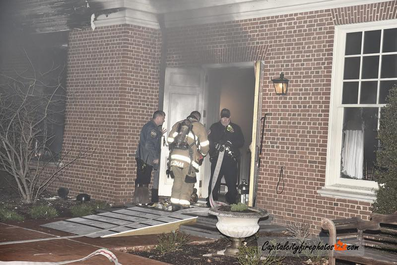 Firefighters extinguish flames after an arsonist set fire to Pennsylvania Governor Josh Shapiro's residence