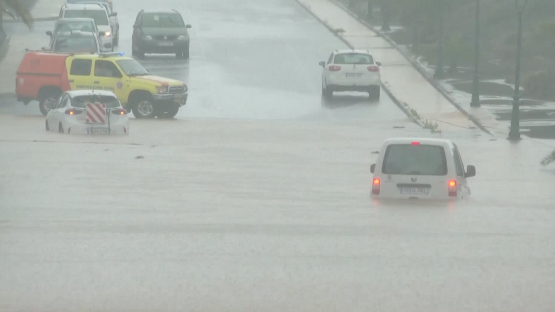Cars were forced to drive through deep flood waters