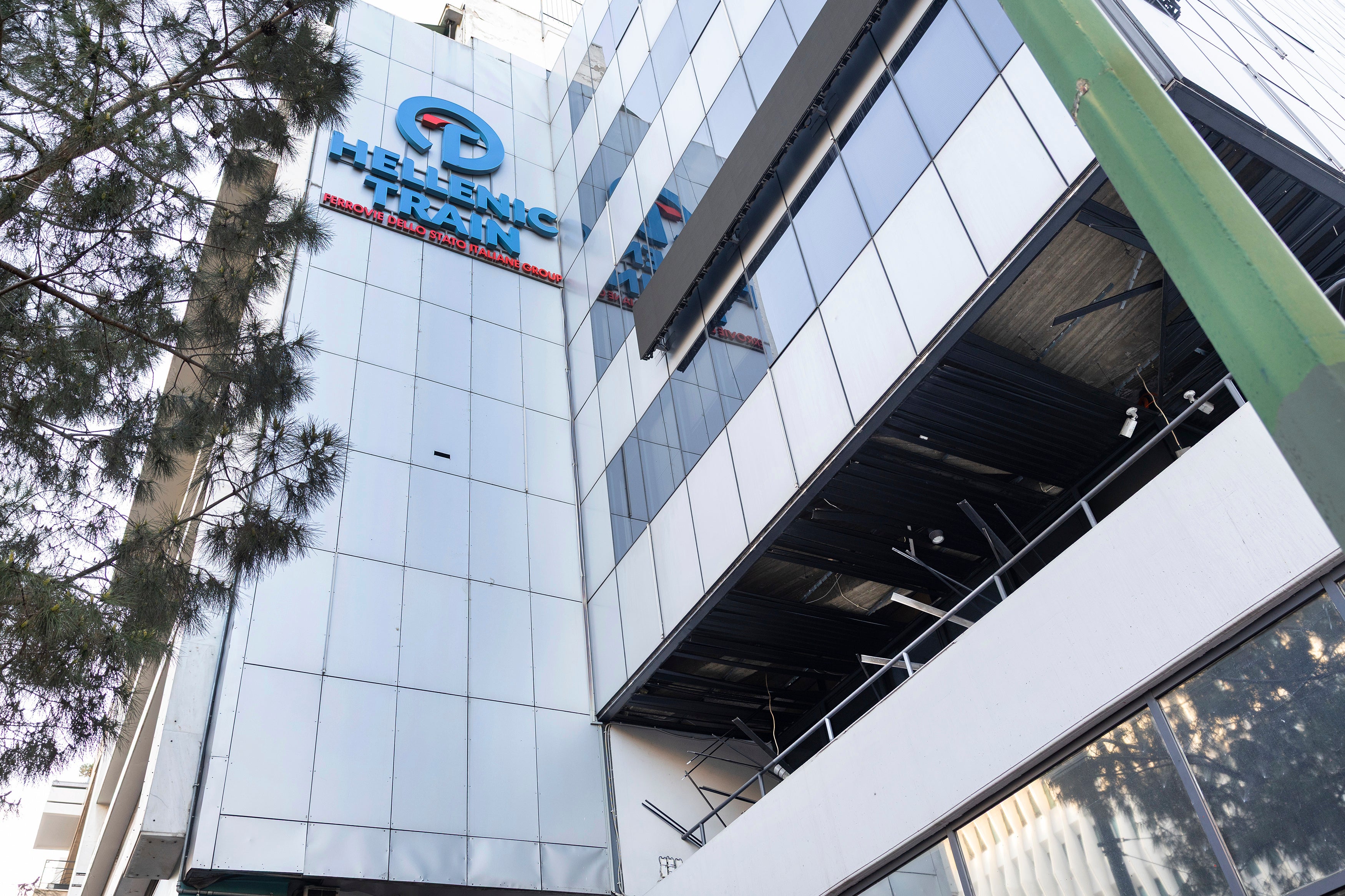 The logo of Hellenic Train, Greece's main railway company, is seen outside company's headquarters, following a bomb explosion Friday night causing causing limited damage but no injuries, in Athens, Greece, on Saturday, April 12, 2025. (AP Photo/Yorgos Karahalis)