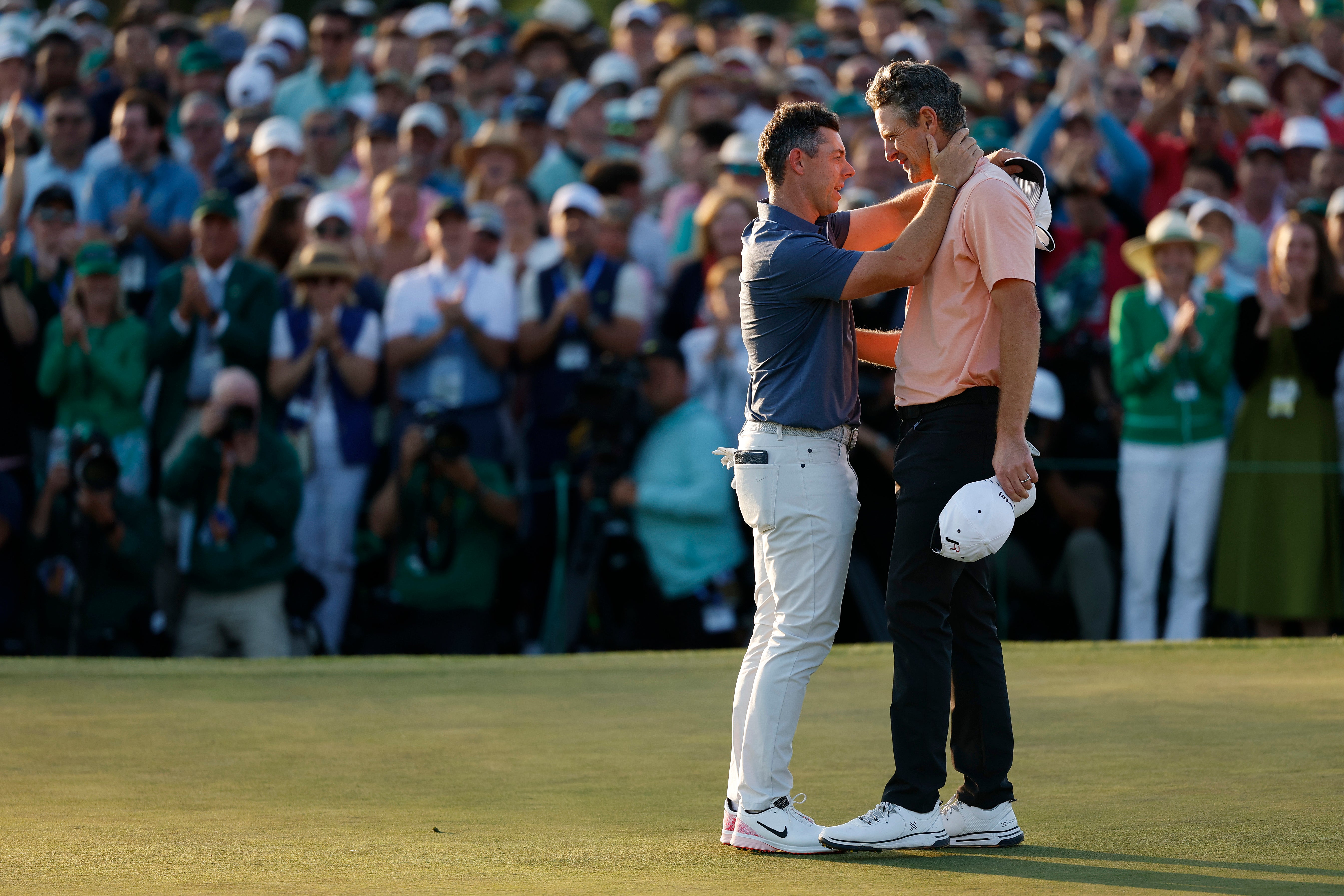 McIlroy and Justin Rose embrace after the play-off