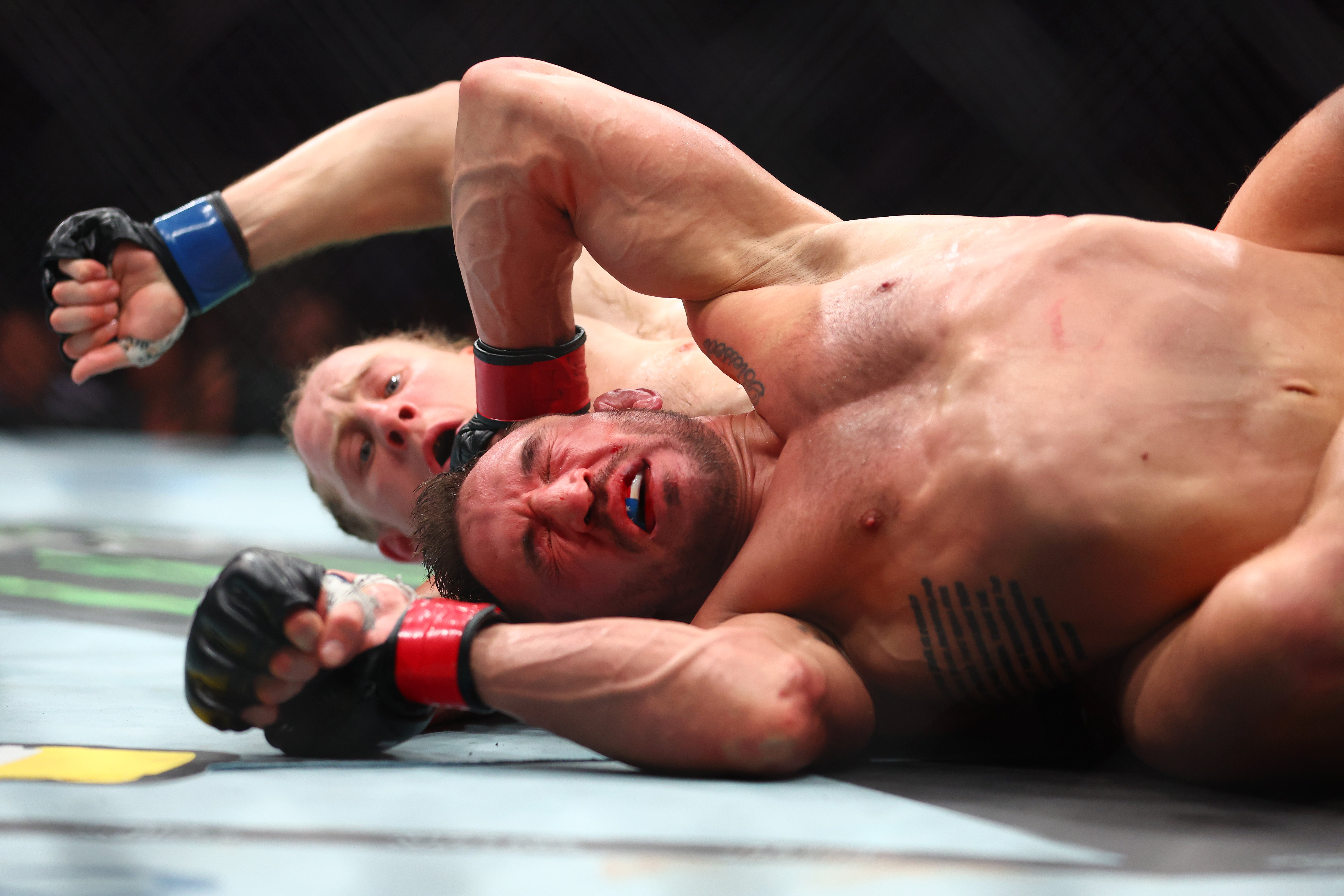 Pimblett (left) controlled Chandler at times and rained down heavy strikes