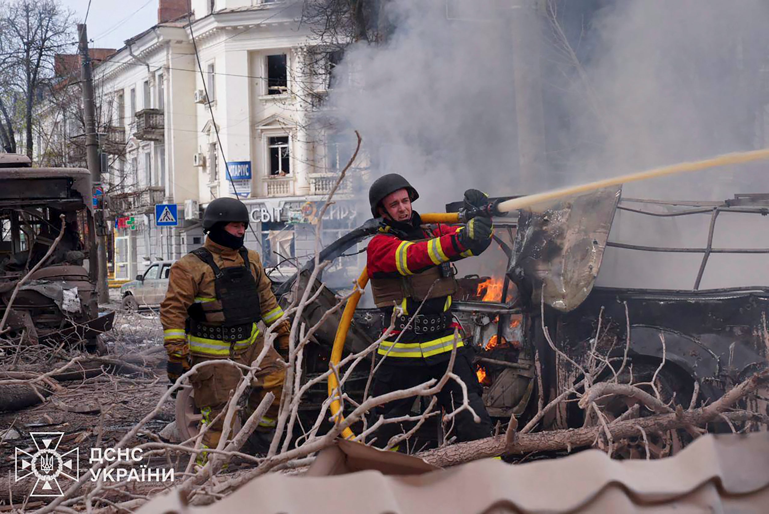 In this handout photograph taken and released by the Ukrainian Emergency Service on April 13, 2025, a Ukrainian rescuers work to extinguish a fire at the site of a missile attack in Sumy, northeastern Ukraine, amid the Russian invasion of Ukraine