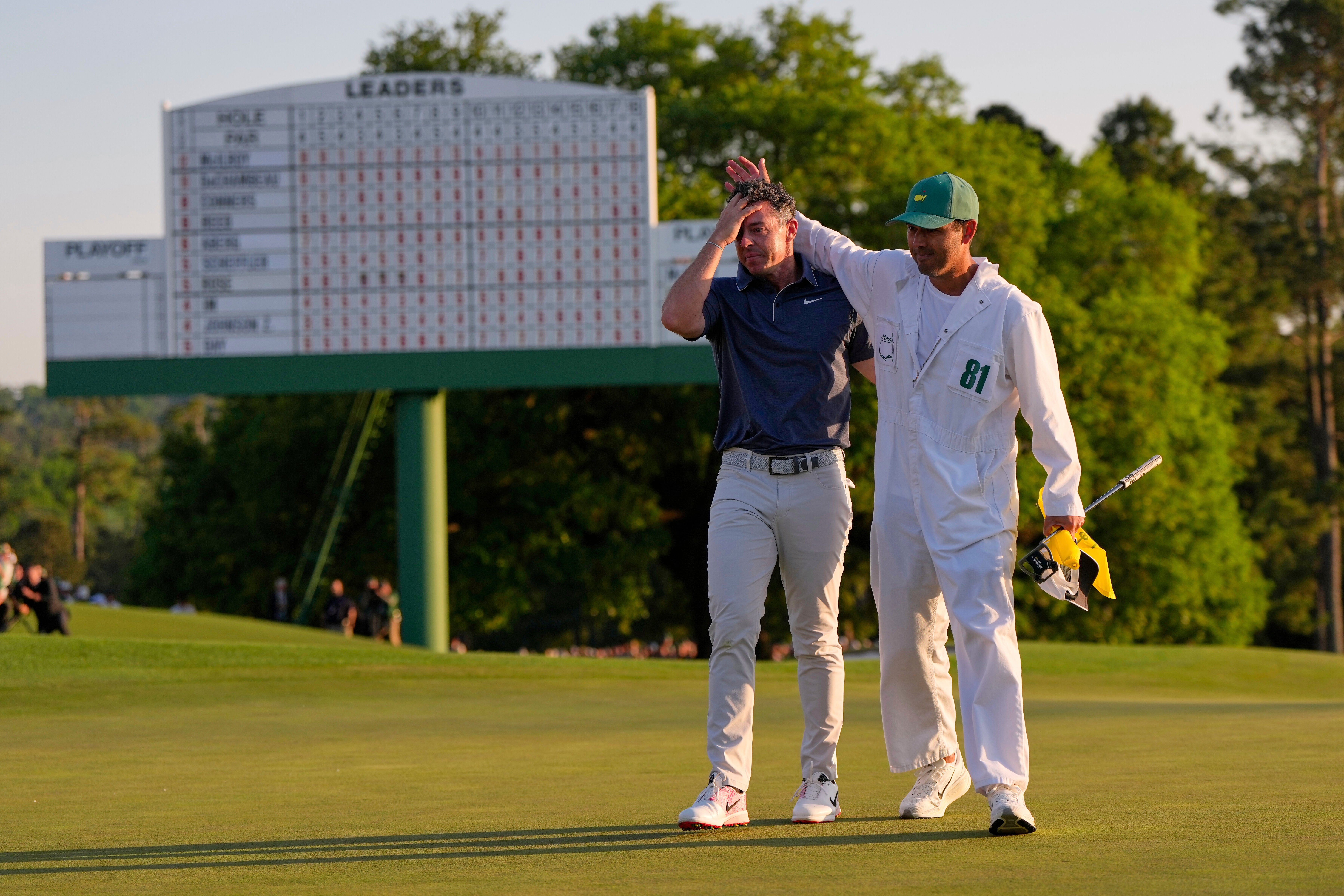 McIlroy celebrates with caddy Harry Diamond
