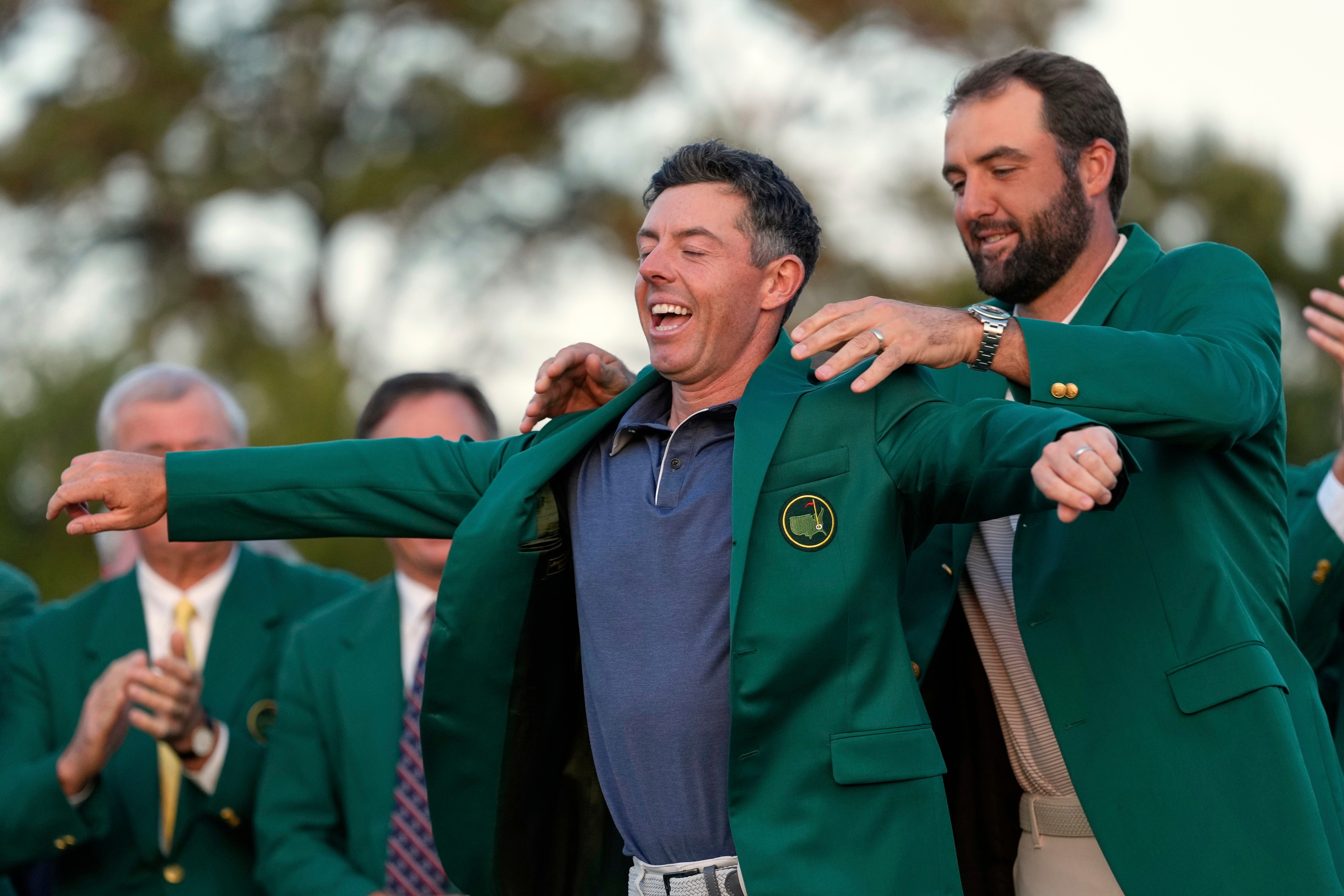 Scottie Scheffler puts the green jacket on new Masters champion Rory McIlroy (Ashley Landis/AP)