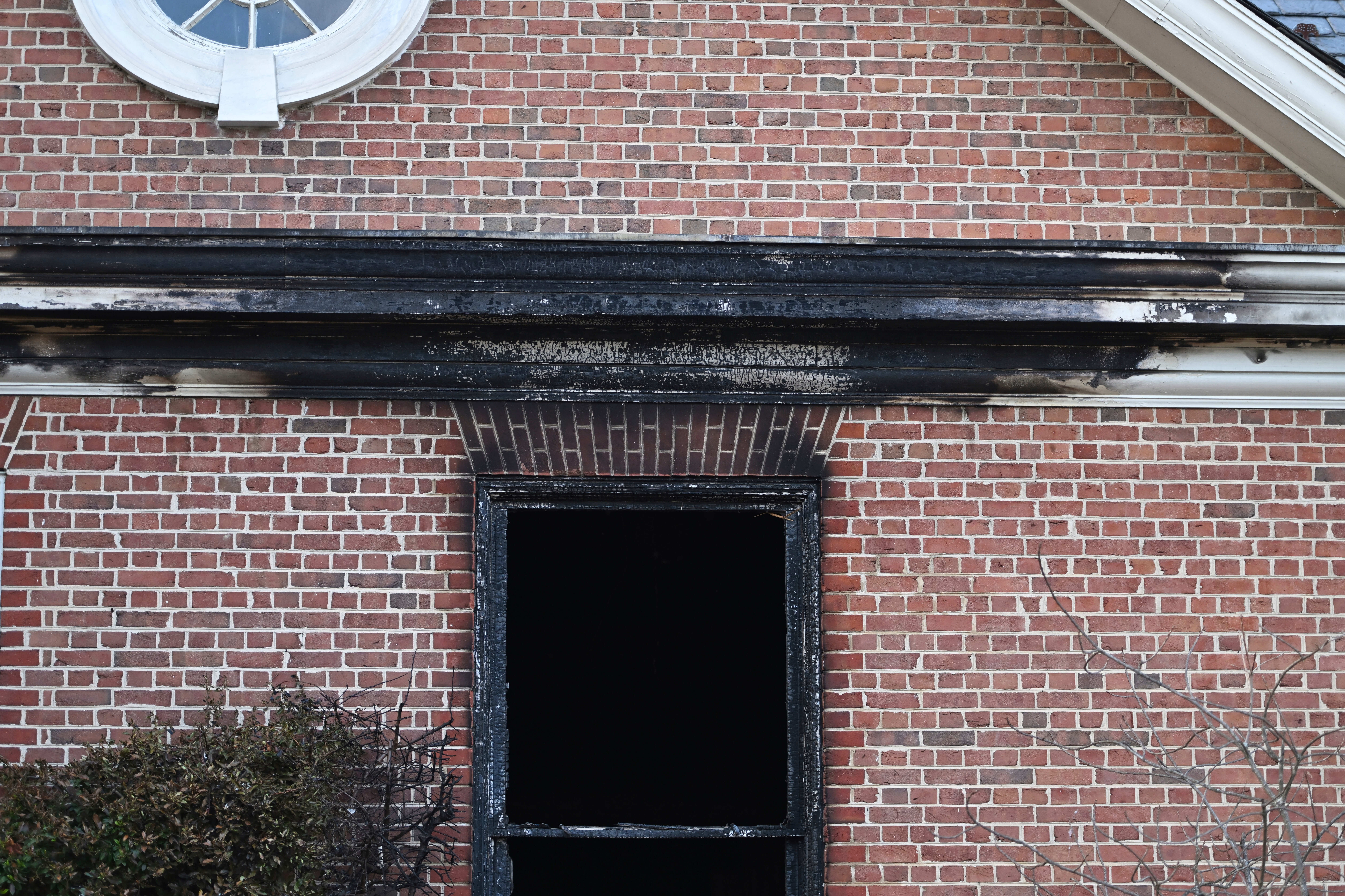Charred wood trim and brick are visible at the Pennsylvania governor's official residence after a man was arrested in the alleged arson that forced Gov. Shapiro, his family and guests to flee in the middle of the night on the Jewish holiday of Passover, Sunday, Apr. 13, 2025, in Harrisburg, Pa. (AP Photo/Marc Levy)