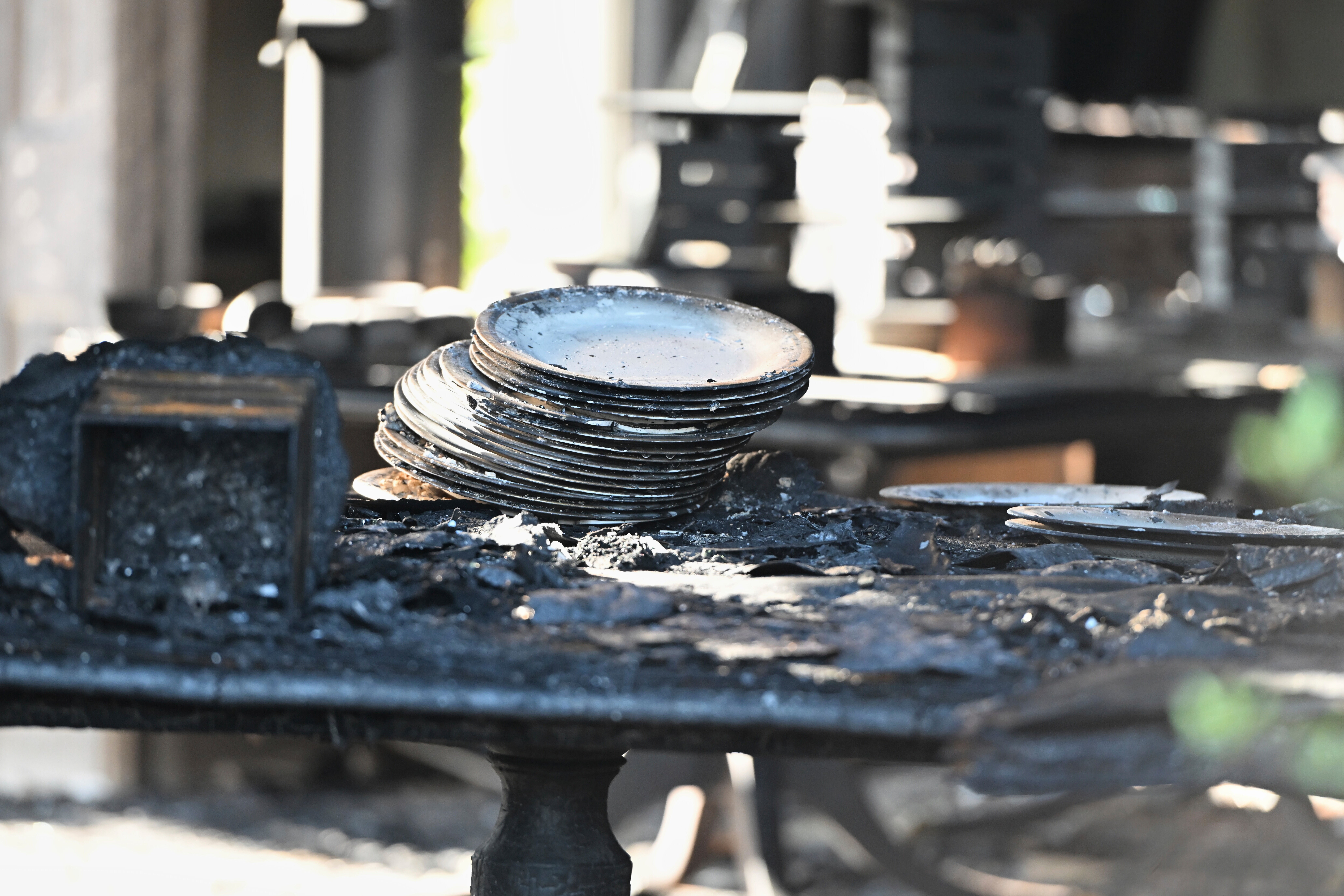 Charred tables and dishes are visible inside the Pennsylvania governor's official residence