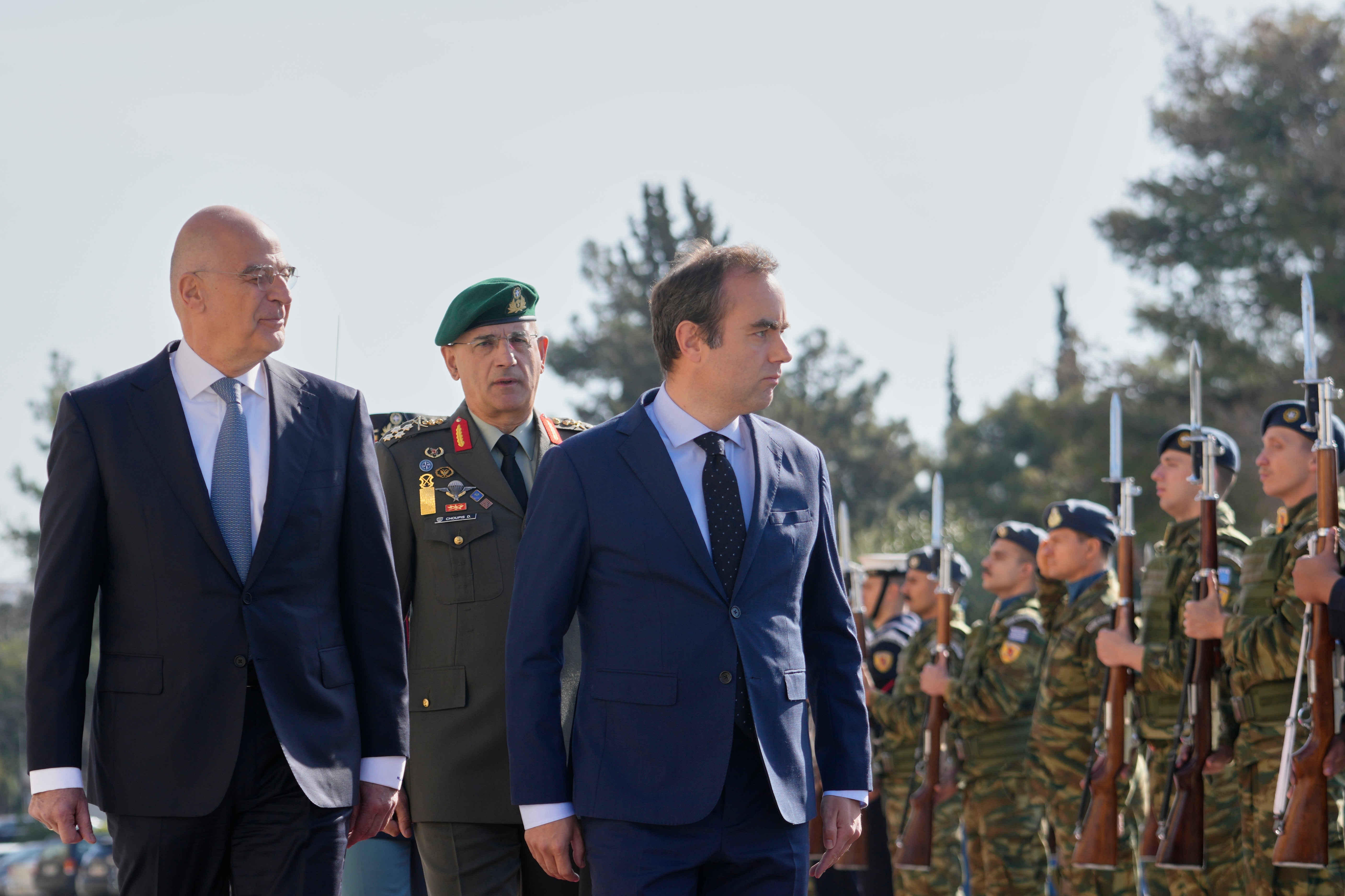 Greek Defense Minister Nikos Dendias, front left, and his French counterpart Sebastien Lecornu, front right, inspect the guard of honour before their meeting in Athens