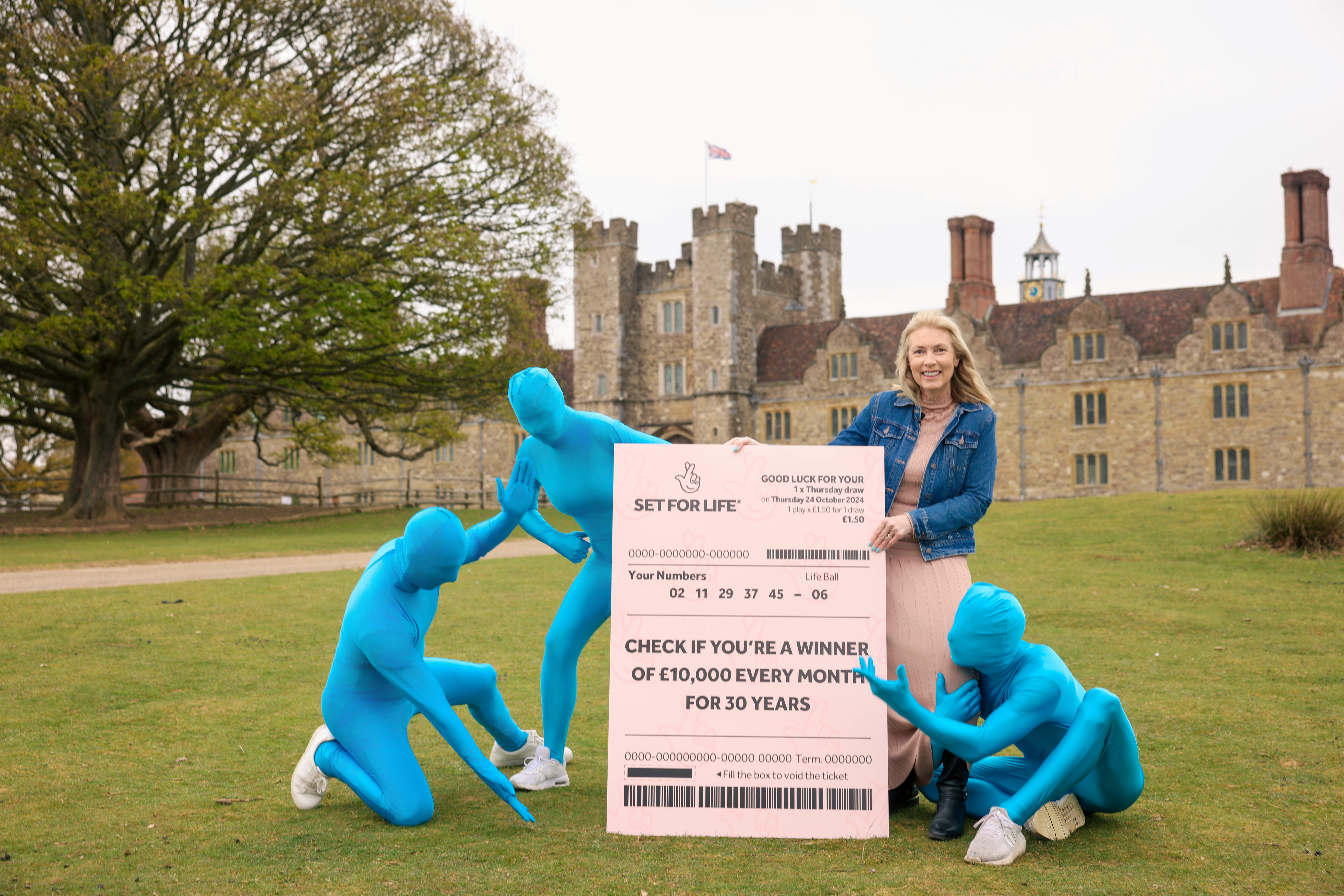 Kathy Garrett and the National Lottery Set For Life Blue Men search for the missing winner in Sevenoaks, Kent