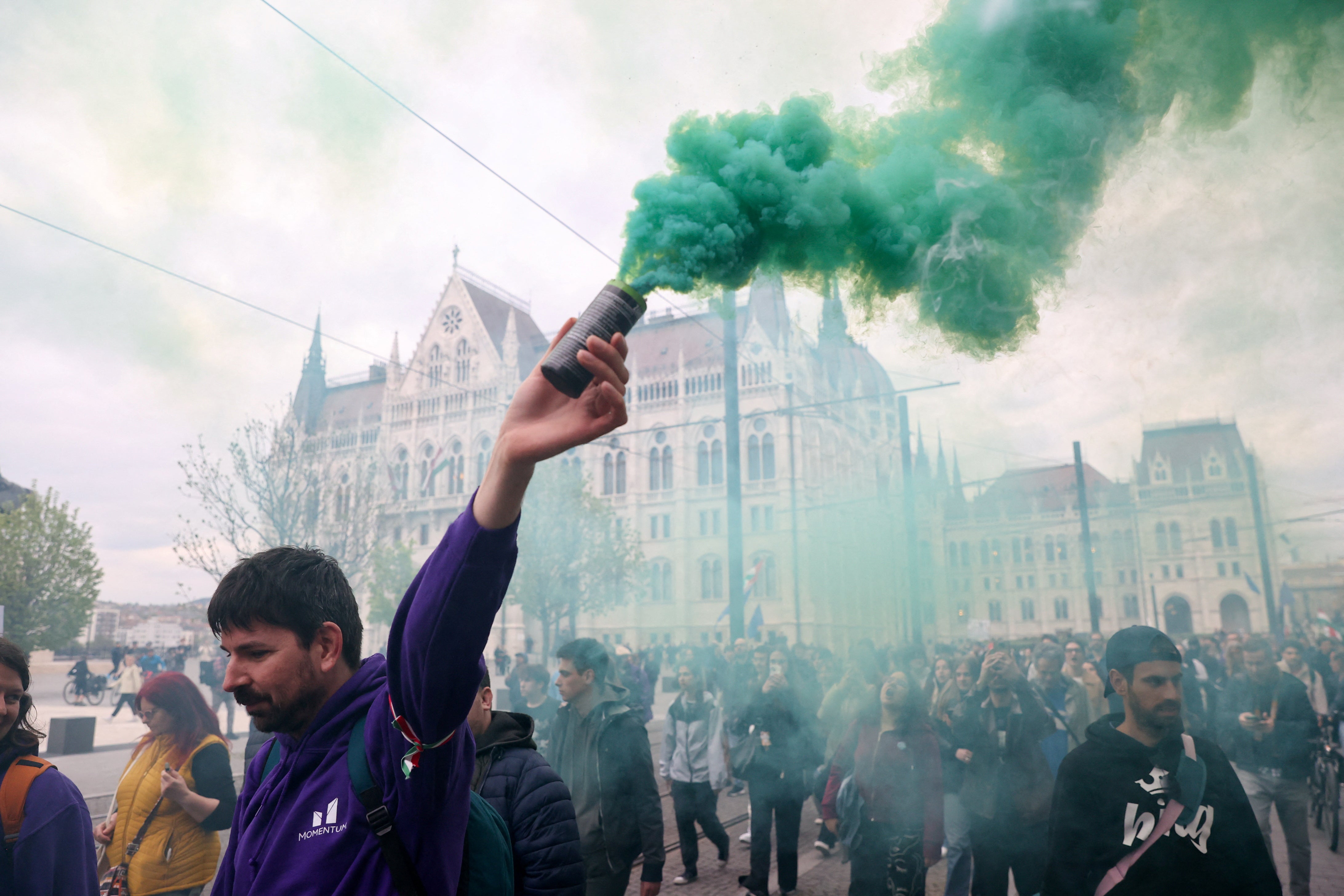 Smoke flares outside Hungary’s parliament on Monday
