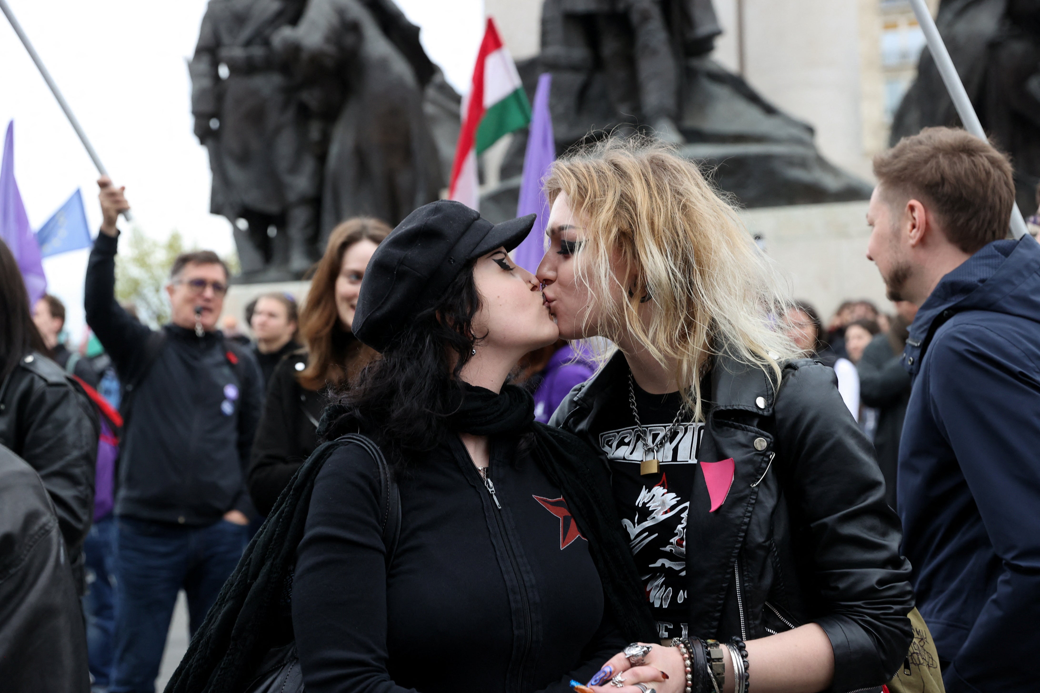 People kiss during a demonstration outside the Hungarian parliament on the day it votes on constitutional amendments targeting the LGBTQ community