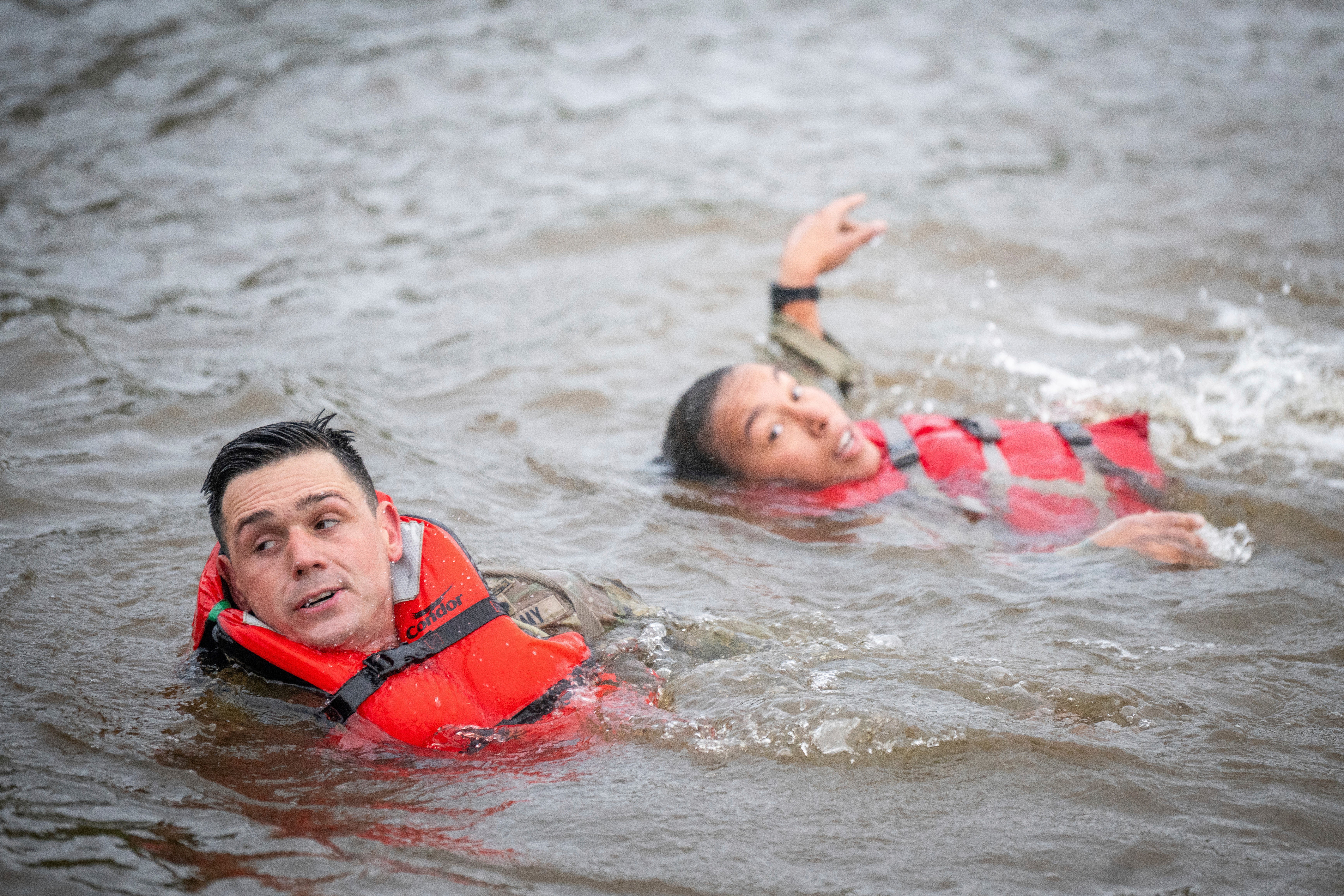 This image provided by the U.S. Army shows Capt. Seth Deltenre, left, and 1st Lt. Gabrielle White, from the Maneuver Center of Excellence in Fort Benning, Ga., as they compete in the "Run-Swim-Run" event during the 2025 Best Ranger Competition, April 11, 2025, at Victory Pond in Fort Benning. (Patrick A. Albright/U.S. Army via AP)