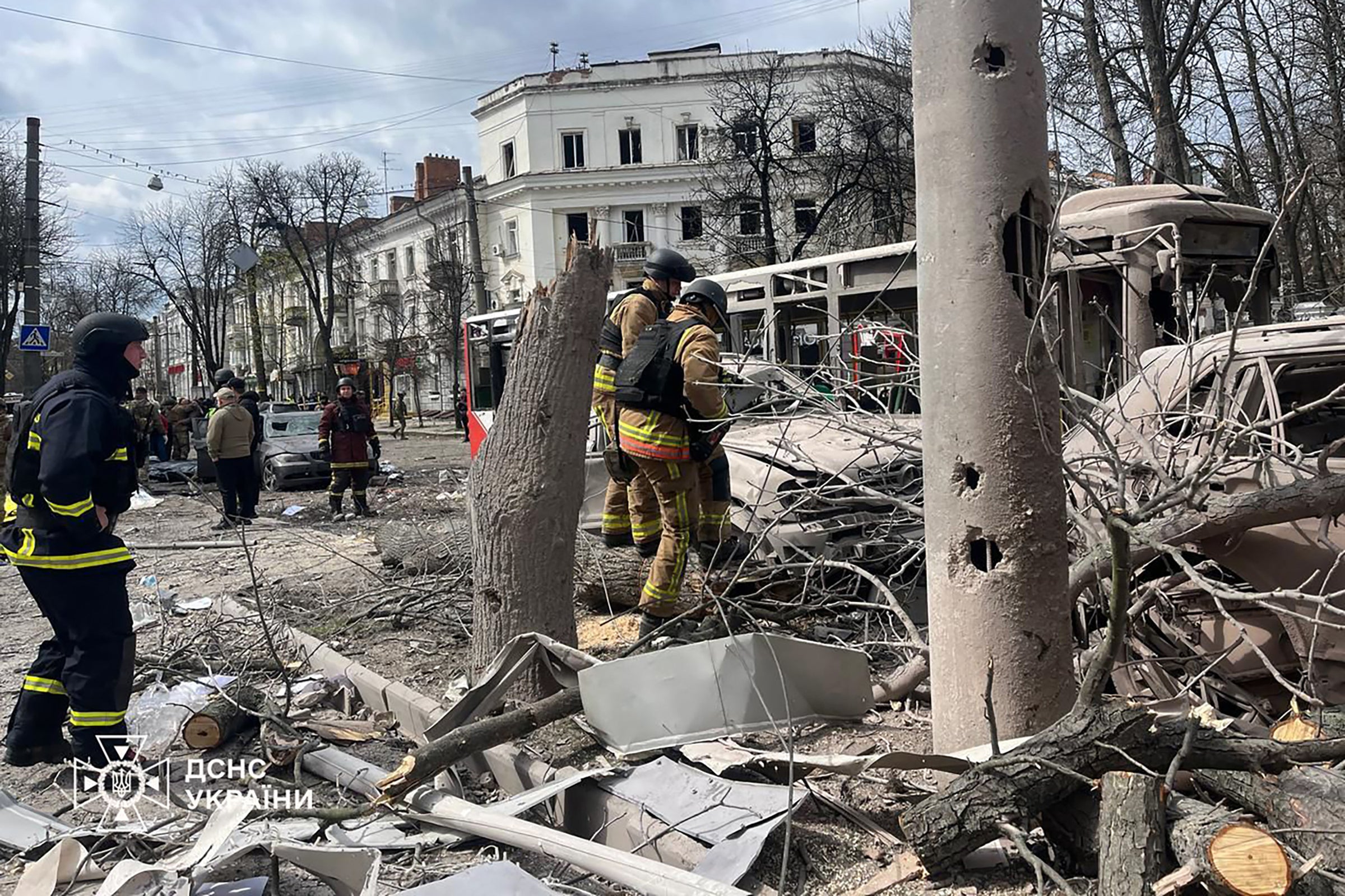 Ukrainian rescuers work at the site of a missile attack in Sumy, northeastern Ukraine