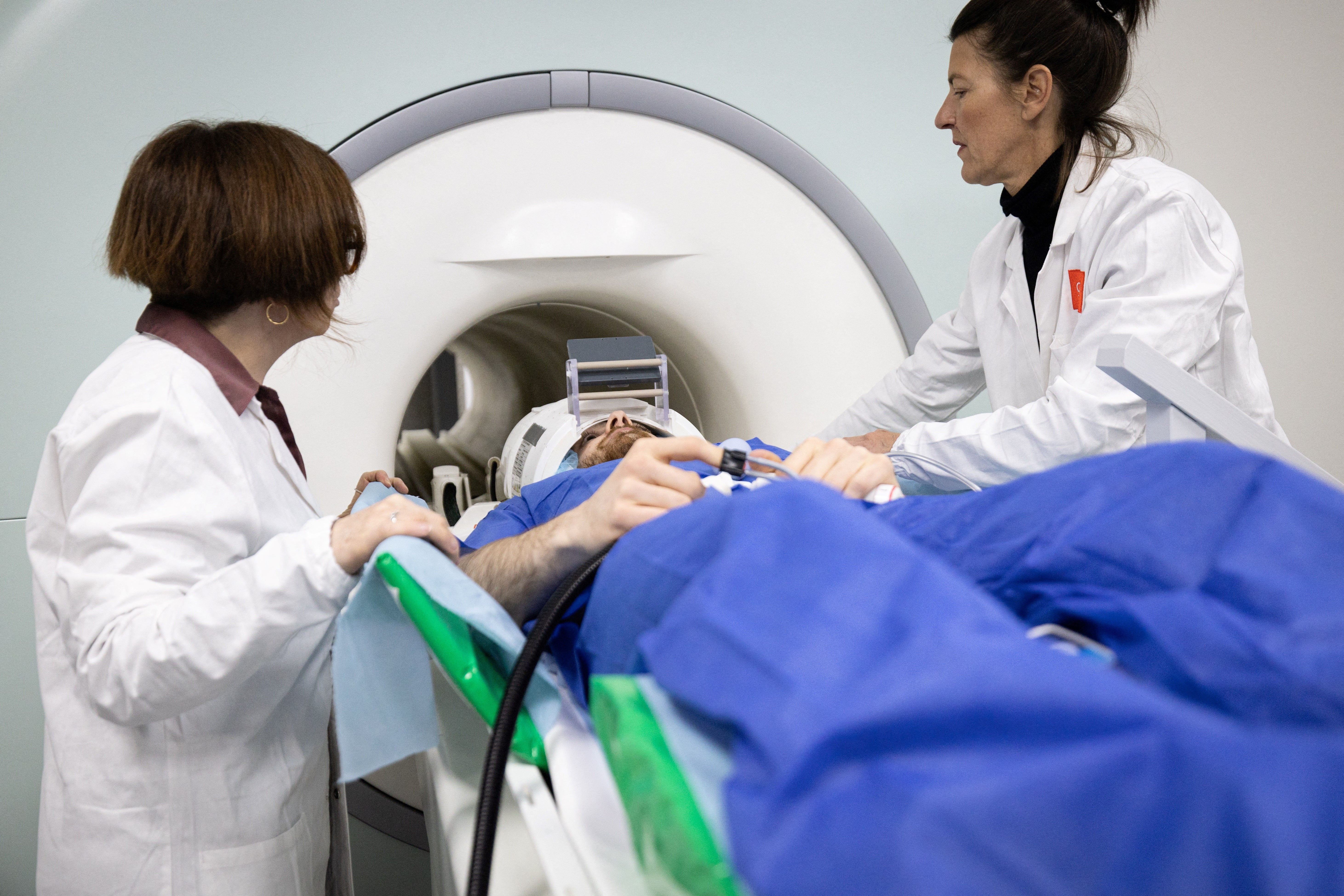 A volunteer takes part in a magnetic resonance imaging exam simulation