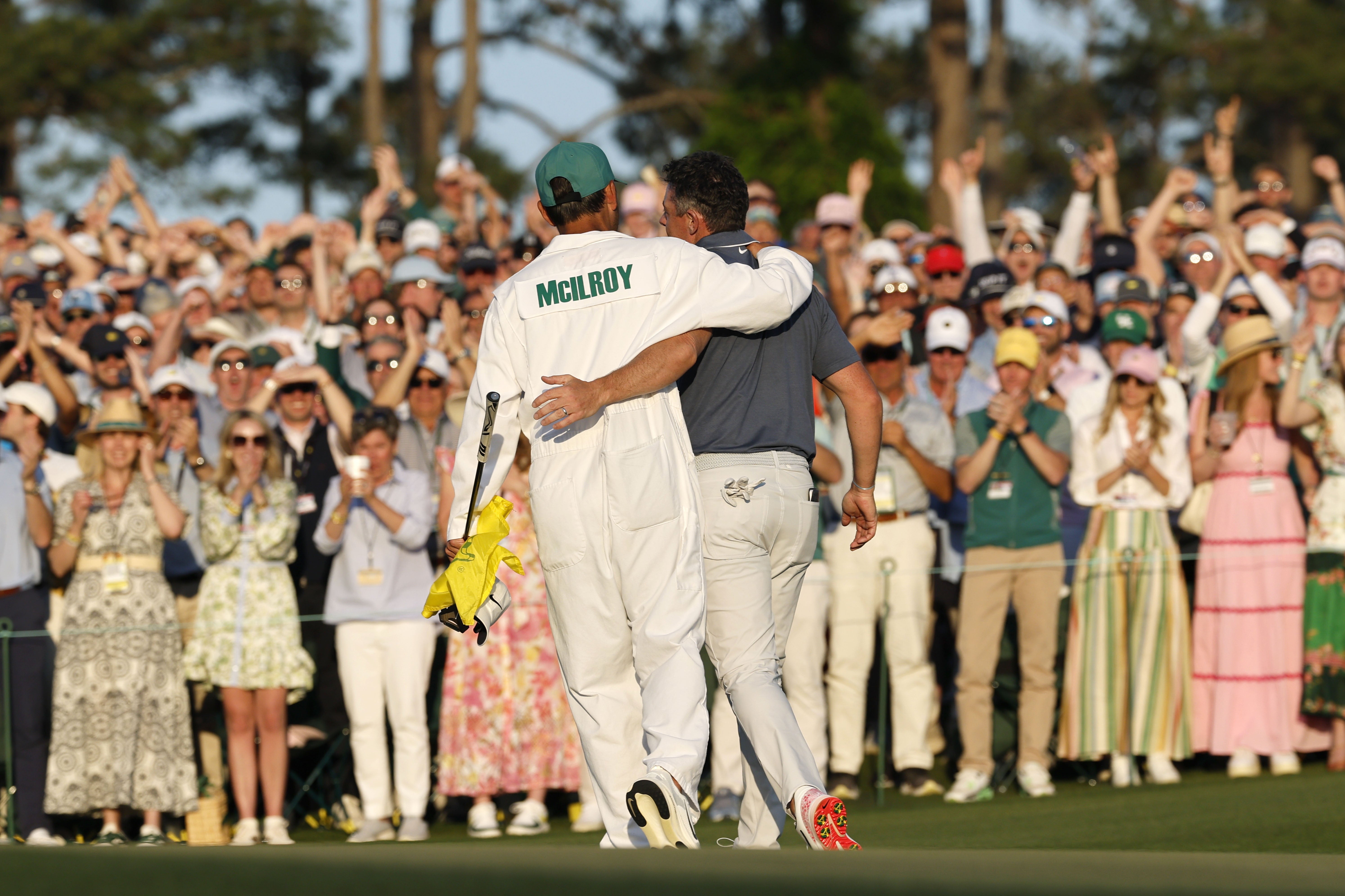 Rory McIlroy (right) and caddie Harry Diamond celebrate winning the Masters on the 18th green at Augusta National