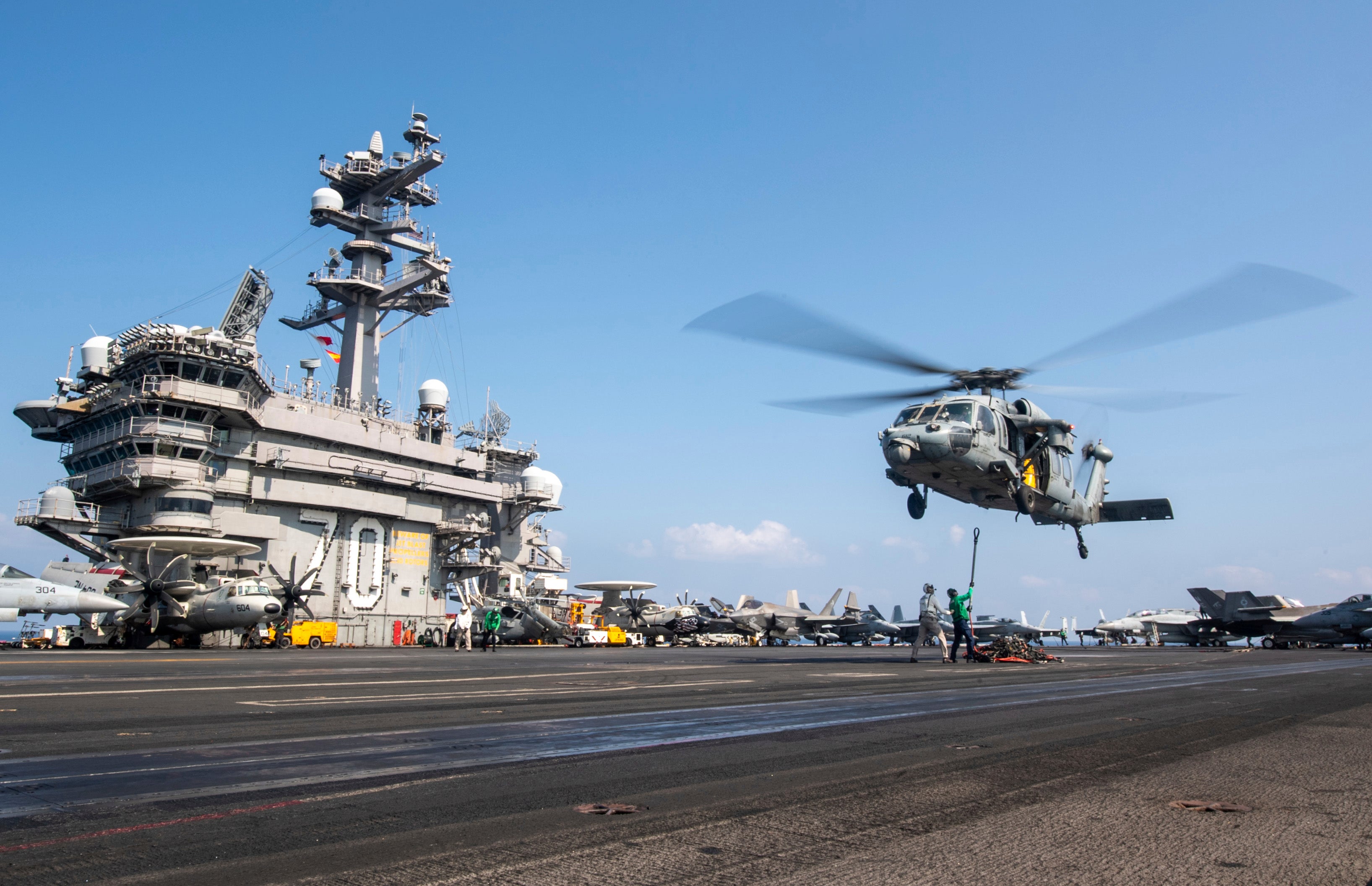 This photograph released by the U.S. Navy shows a MH-60S Sea Hawk helicopter hovering over the USS Carl Vinson aircraft carrier while operating in the Middle East on April 12, 2025
