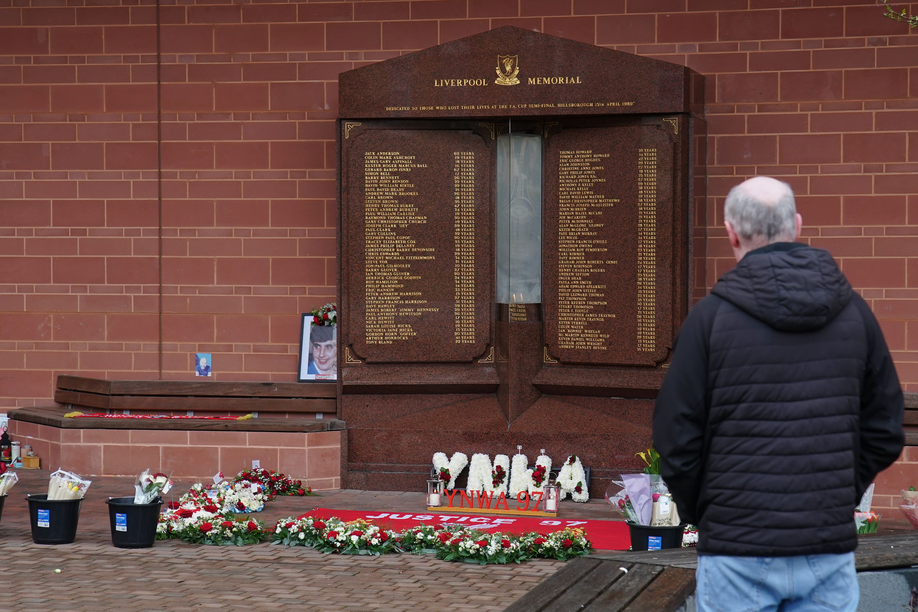Floral tributes are left by the Hillsborough Memorial at Anfield on the 36th anniversary of the football stadium disaster (Peter Byrne/PA)