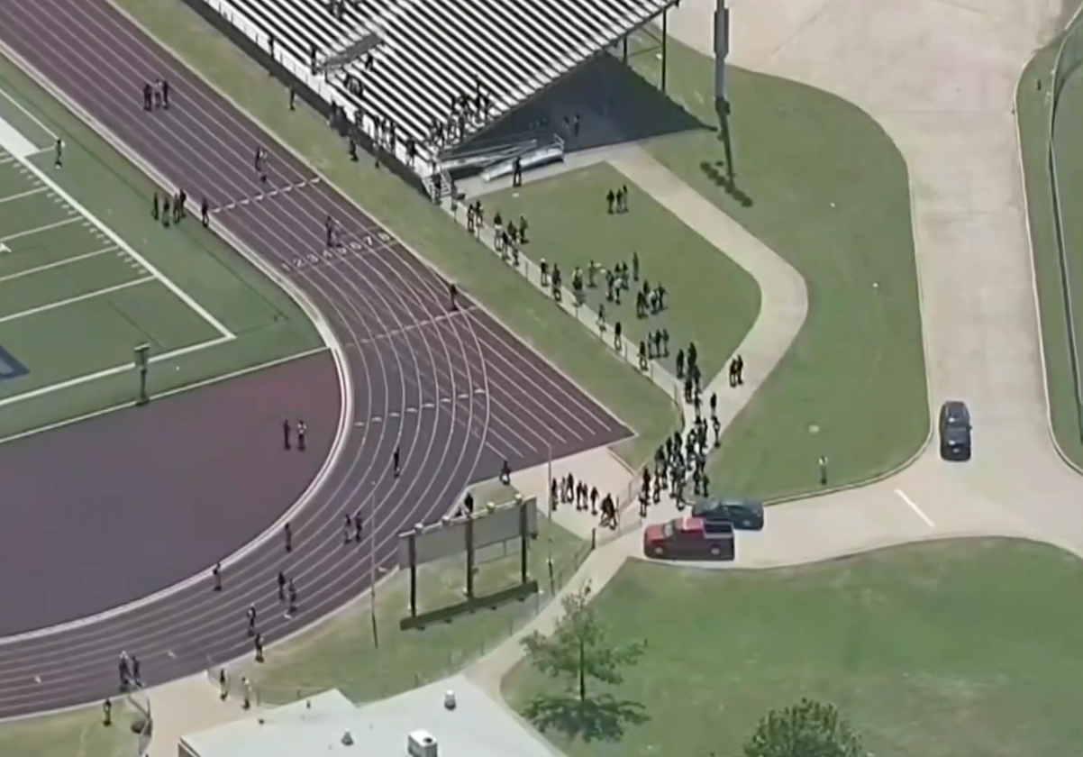 Students at Wilmer-Hutchins High School in Dallas, Texas evacuate after a shooting