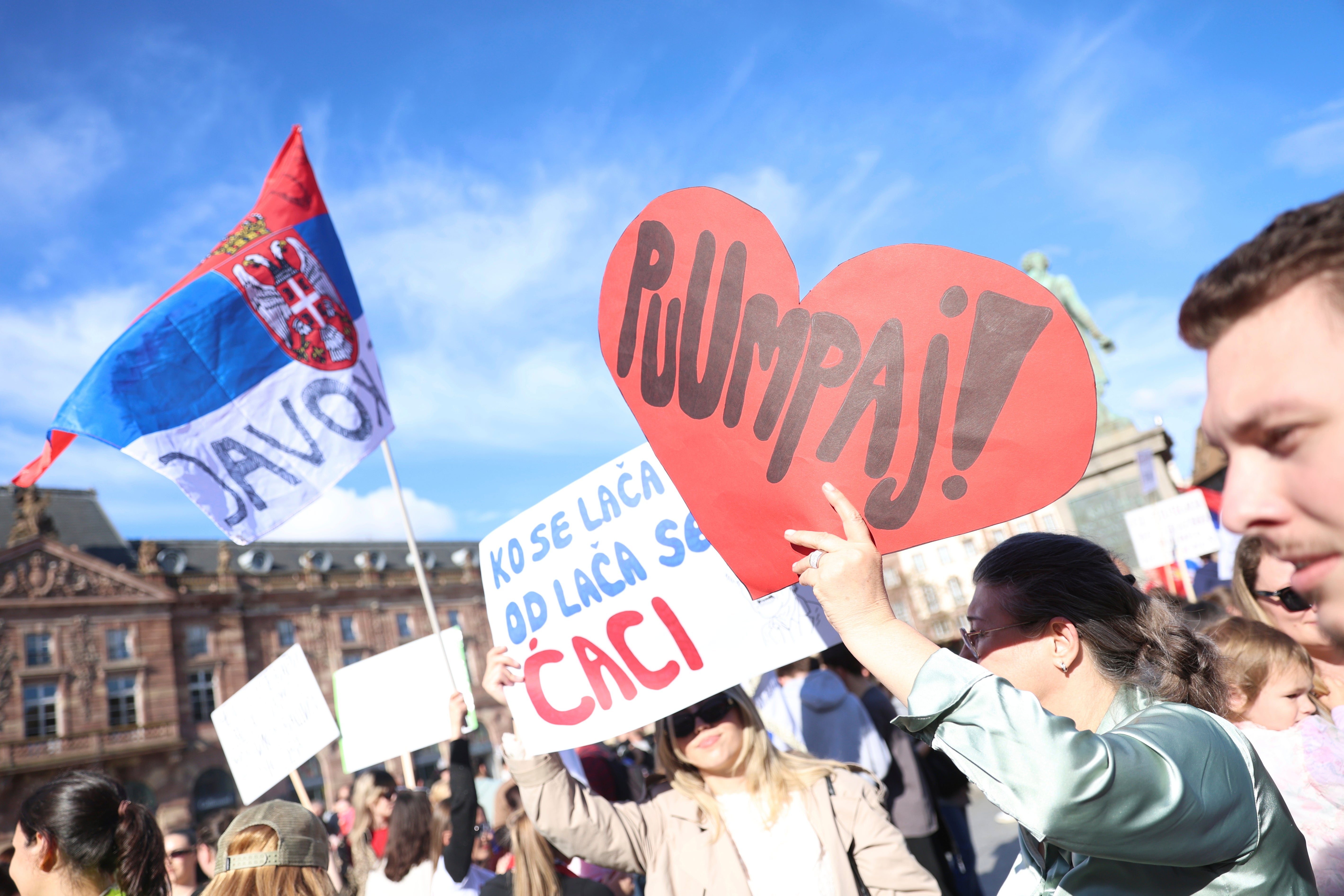 Protesters hold to welcome Serbian university students who have cycled from Serbia to France, 15 April, 2025 (AP Photo/Antonin Utz)