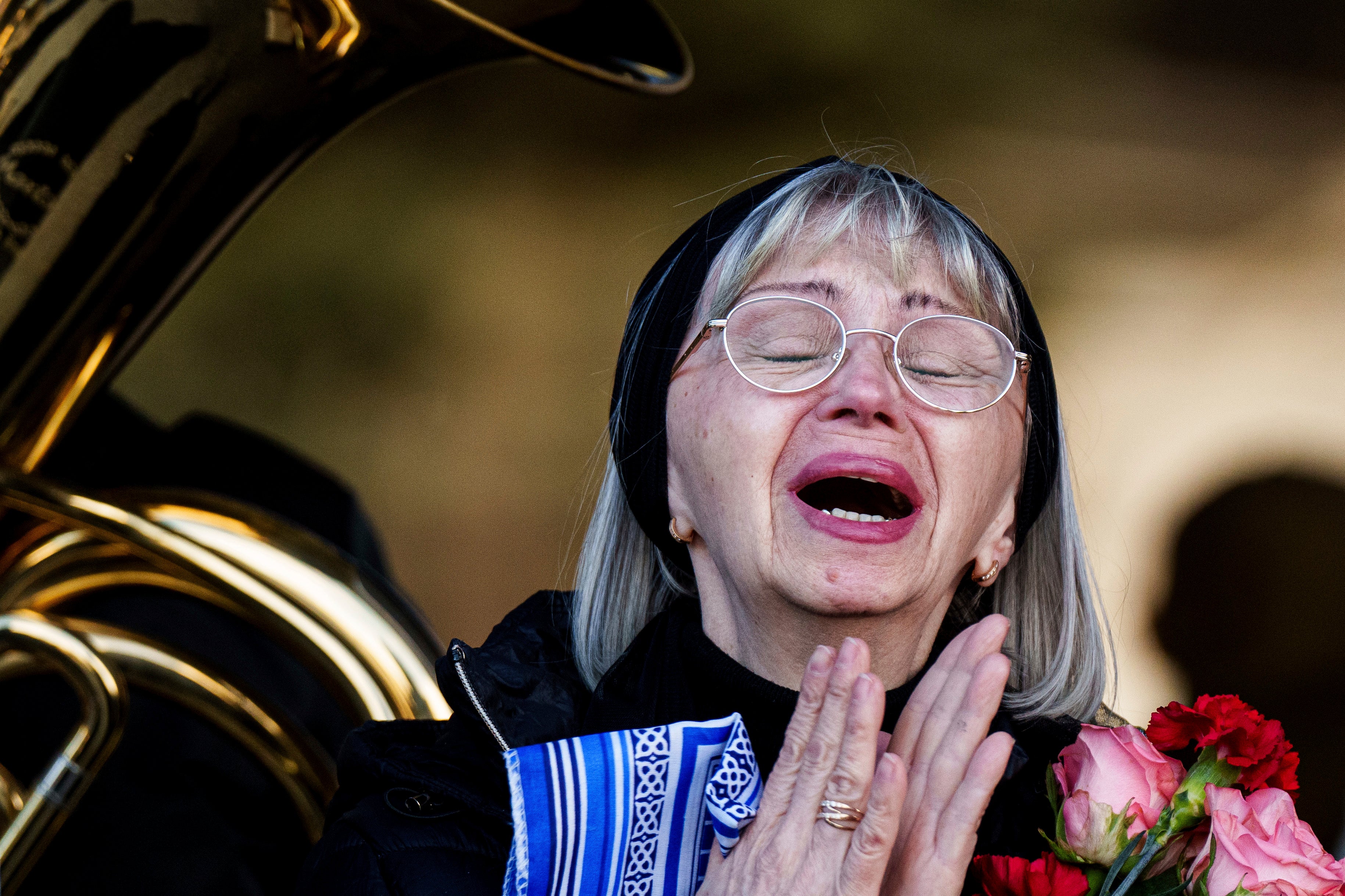 A woman cries during farewell ceremony of Olena Kohut, who was killed in the deadly Russian attack on Sumy, Ukraine, 15 April 2025