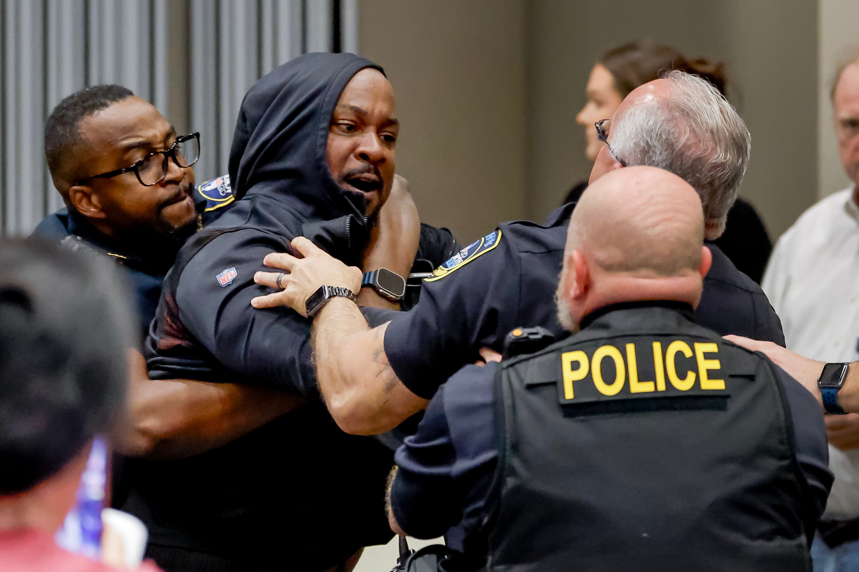 Another protester resists being removed by police