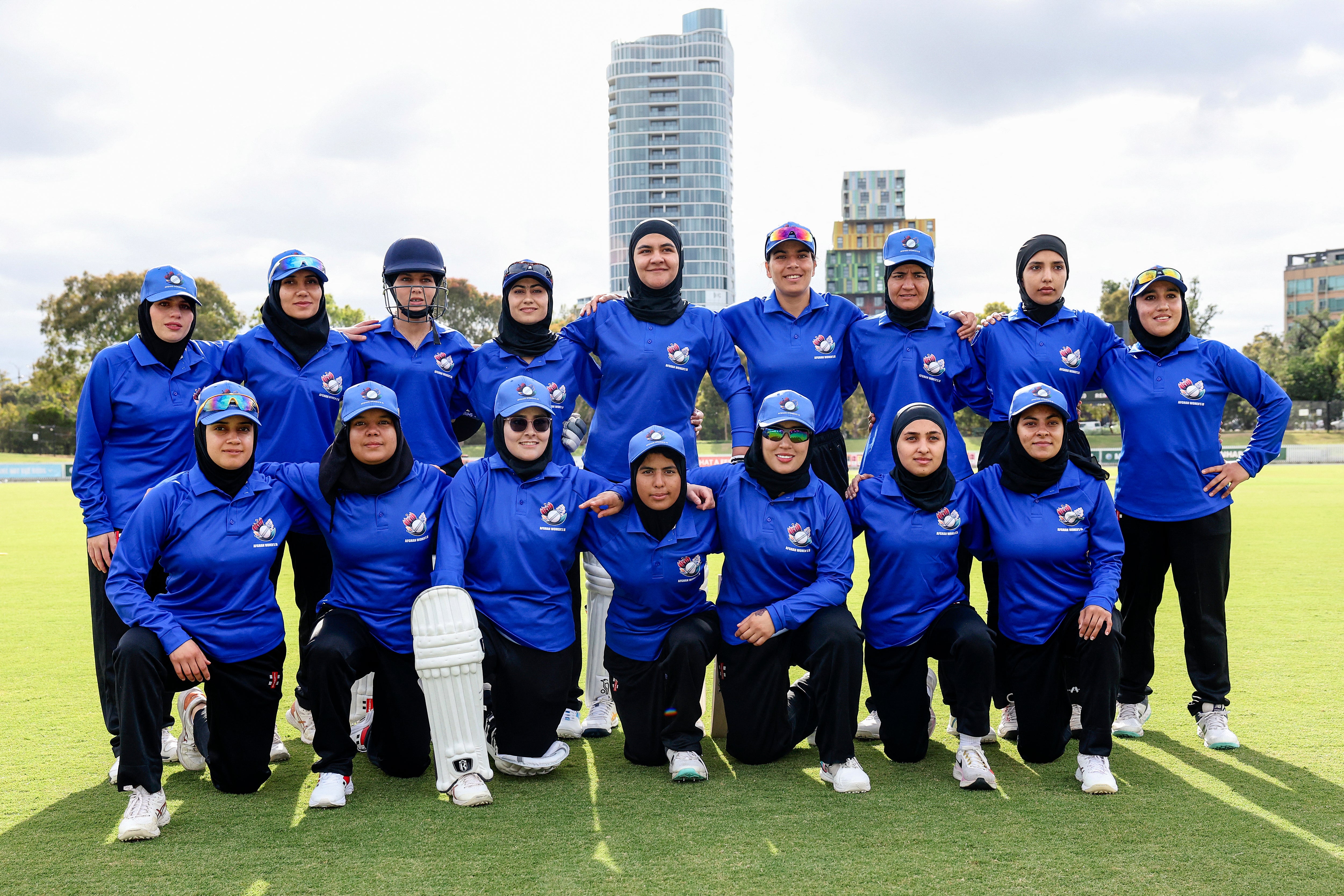 Afghanistan Women's XI players pose for a team photo during the cricket match between Afghanistan Women's XI and Cricket Without Borders XI at Junction Oval in Melbourne
