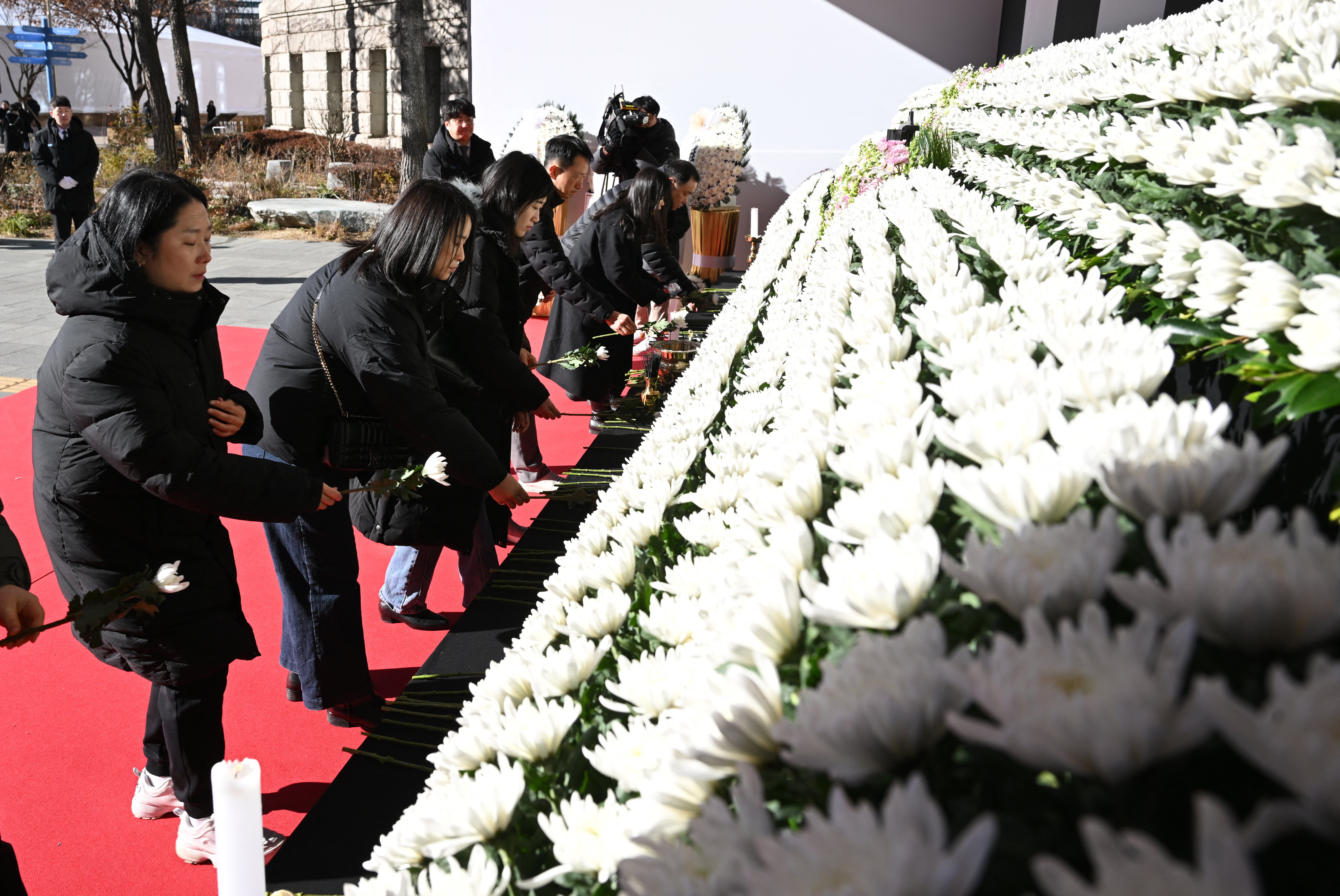 Mourners pay respects at a memorial altar for the victims of the Jeju Air crash in front of the Seoul City Hall on 31 December 2024