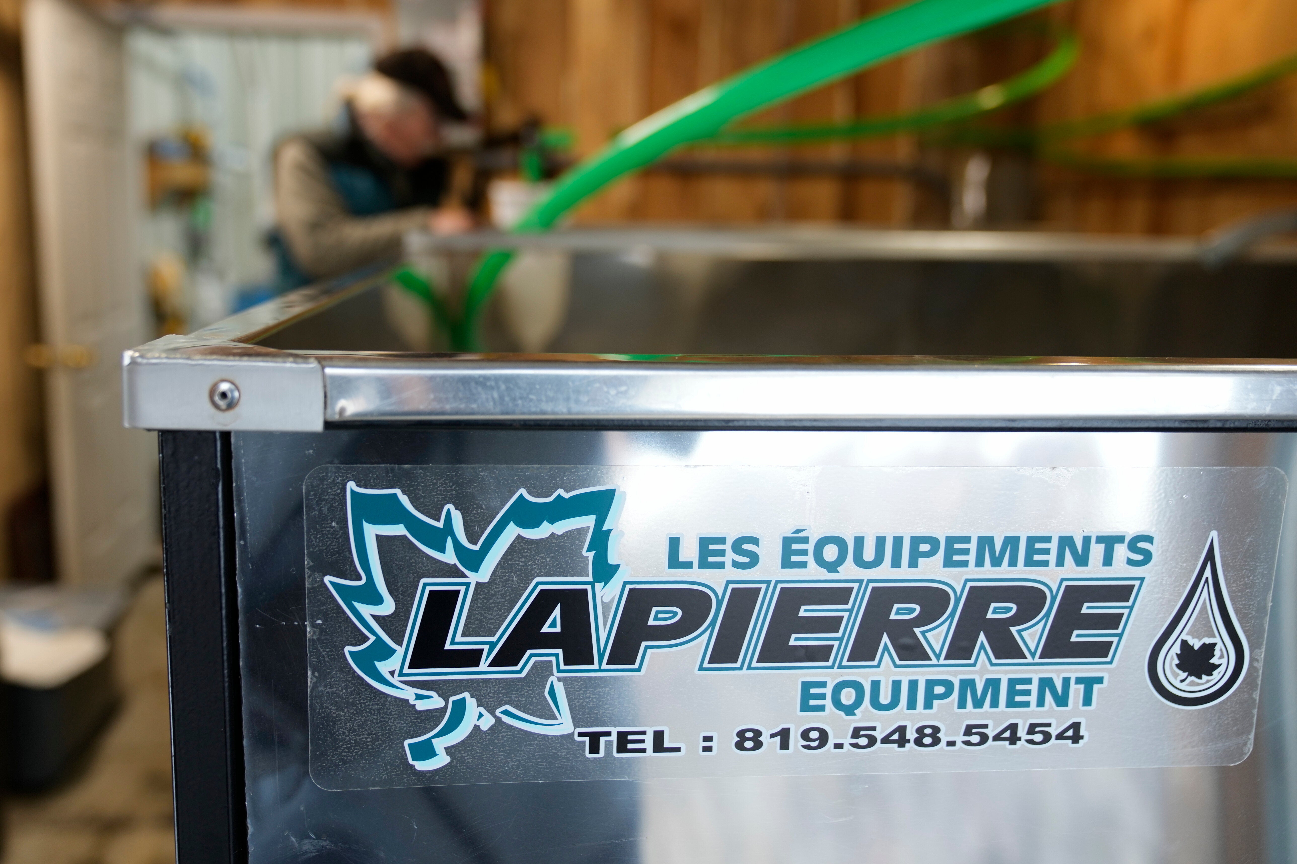 Maple syrup producer Jim Judd checks on the levels of sap in a stainless steel tank imported from Quebec, Canada, at Judd's Wayeeses Farms in Morgan, Vt., on Friday, April 11, 2025.